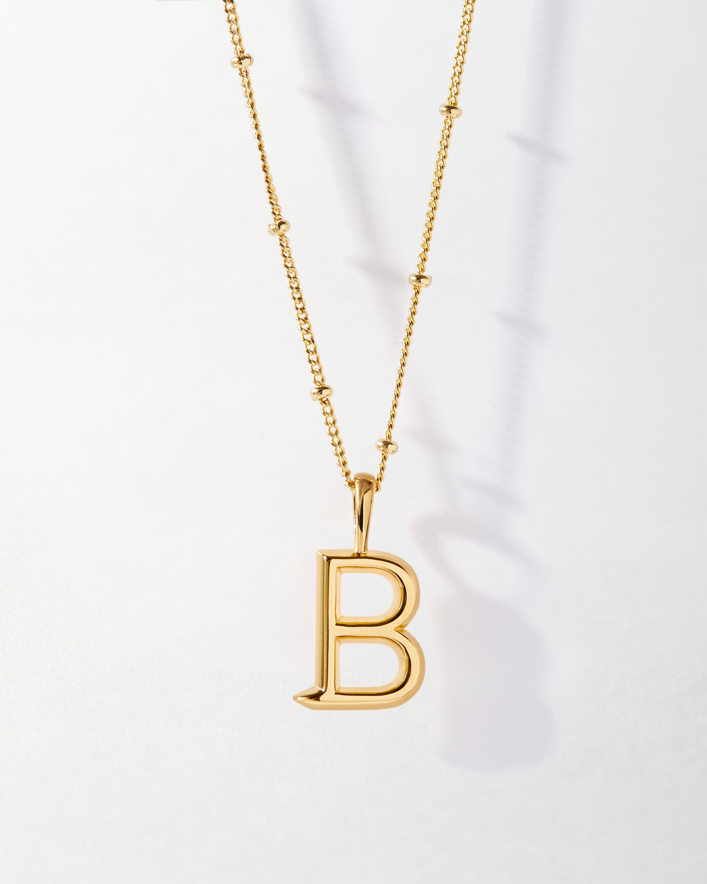B' Initial Necklace - Gold featuring a fine gold-plated pendant in the shape of the letter B on a delicate chain, crafted from recycled metals with ethical sourcing for everyday luxury.