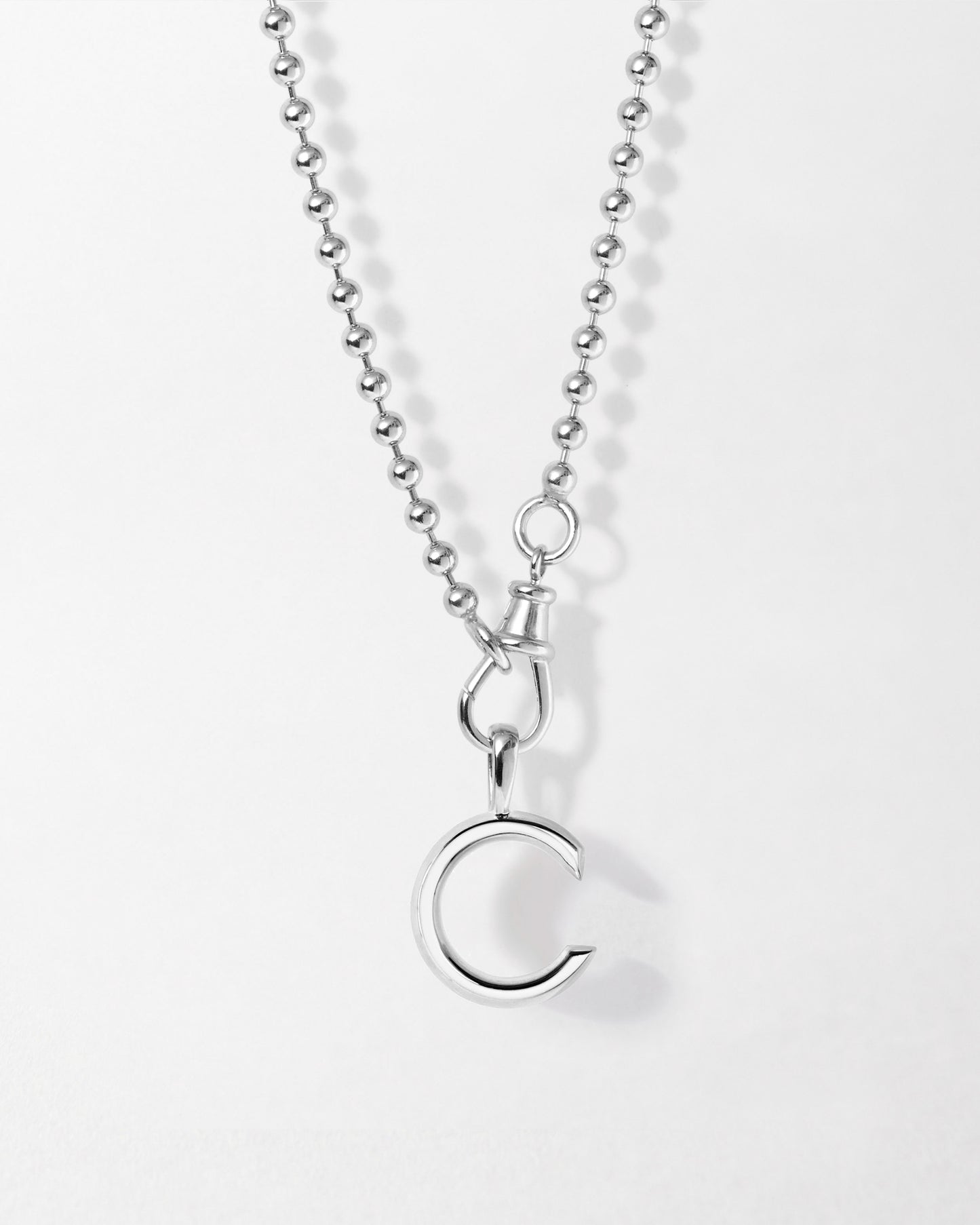 Initial Globe Necklace - Silver featuring a sterling silver pendant shaped like the letter C on a delicate chain, crafted from recycled metals with ethical sourcing.