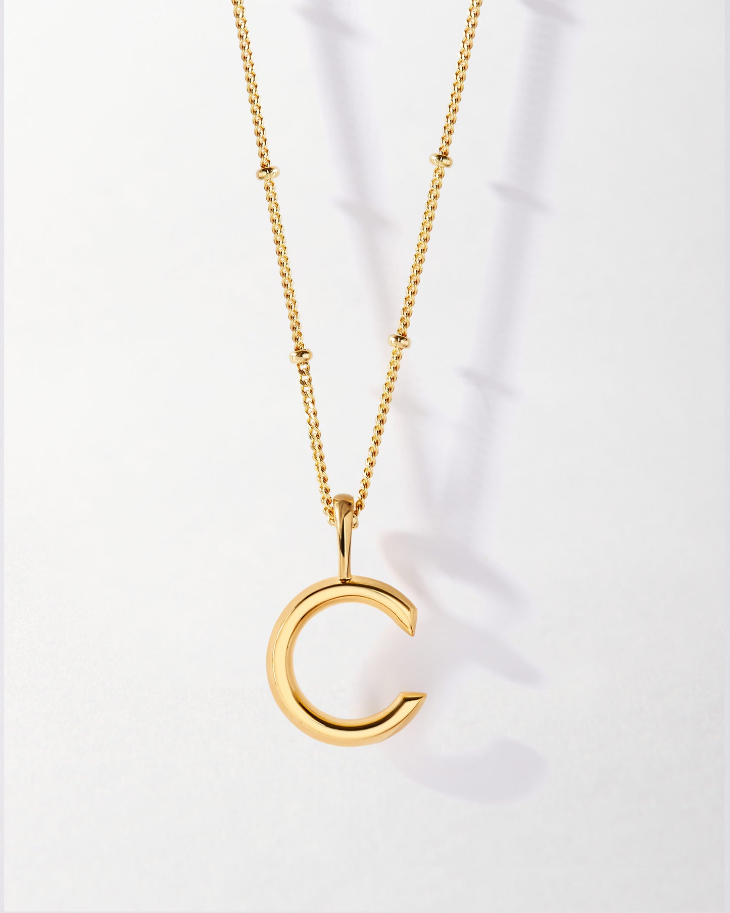 C' Initial Necklace - Gold featuring a sleek gold-plated pendant on a delicate chain, crafted from recycled metals for fine, ethical everyday jewellery built to last.