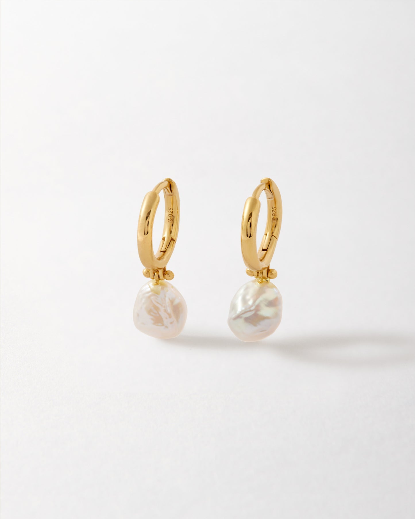 Coastal Pearl Earrings featuring gold-plated stud hoops with delicate natural pearls, crafted in recycled metals for considered jewellery that combines everyday luxury and ethical sourcing.