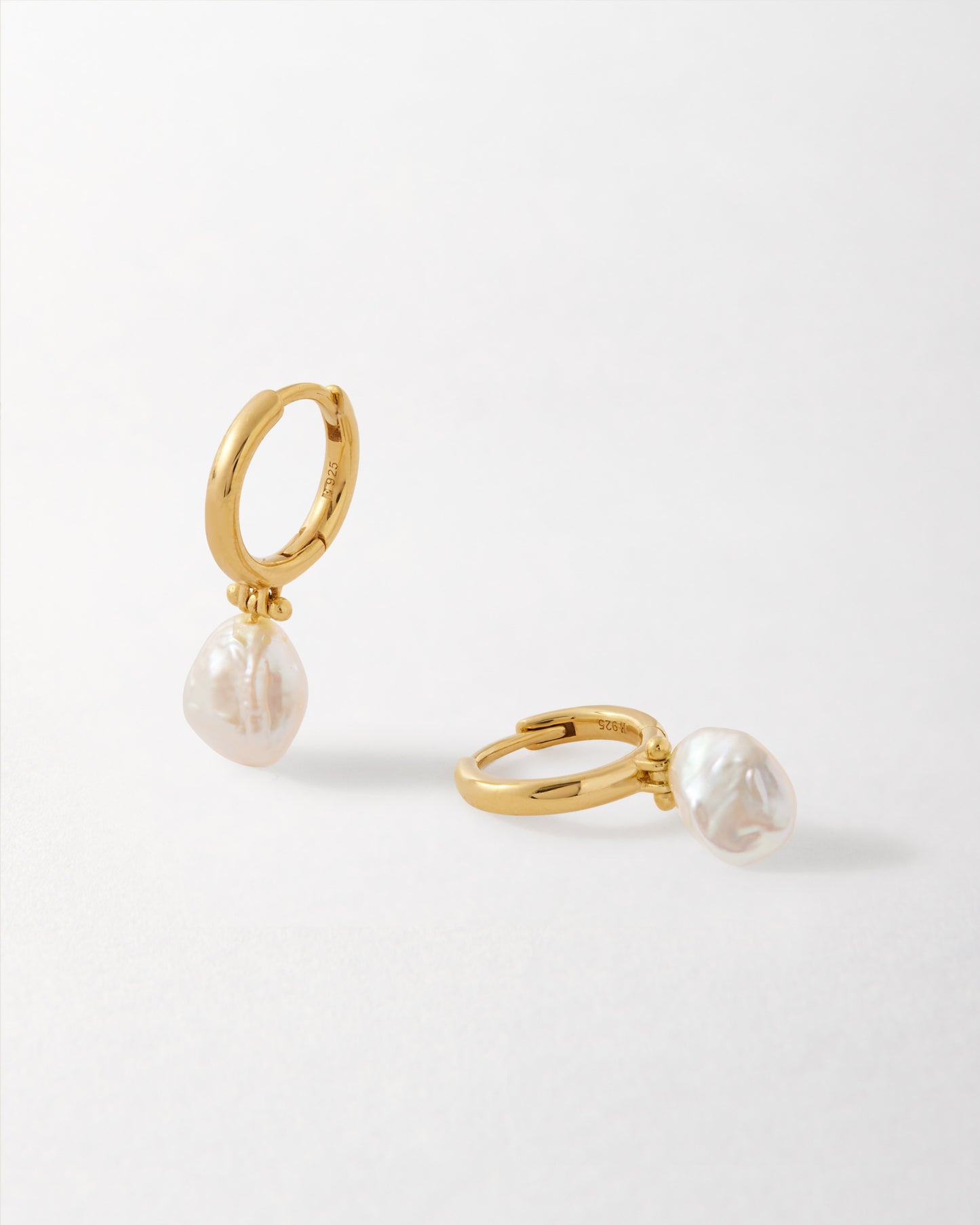 Coastal Pearl Earrings featuring gold-plated sterling silver studs with delicate pearls, crafted from recycled metals for considered jewellery that’s built to last.