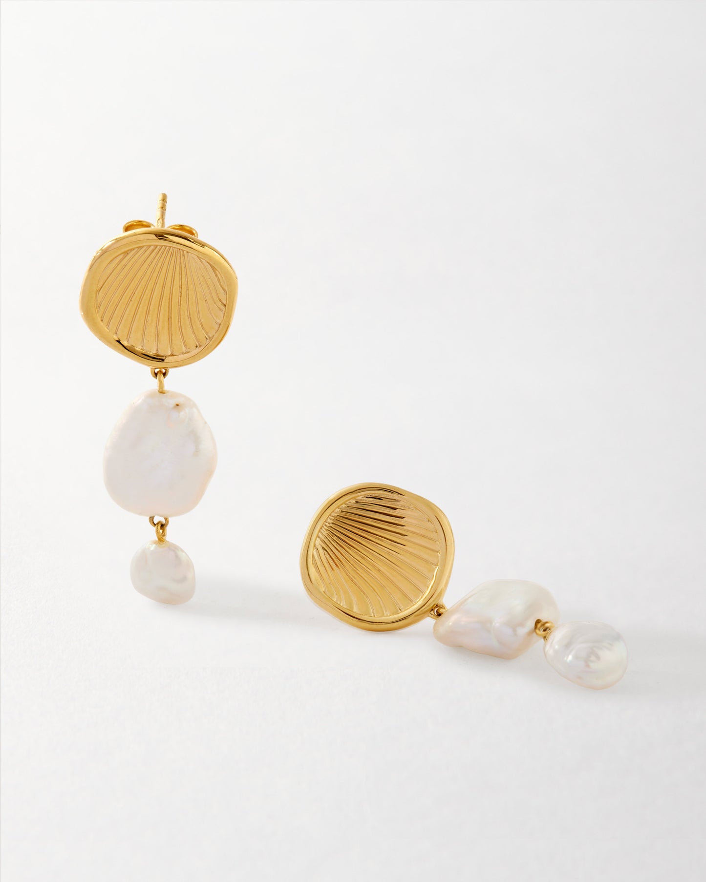 Coastal Pearl Statement Earrings featuring gold-plated stud design with two natural freshwater pearls, crafted from sterling silver and recycled metals for fine everyday jewellery.