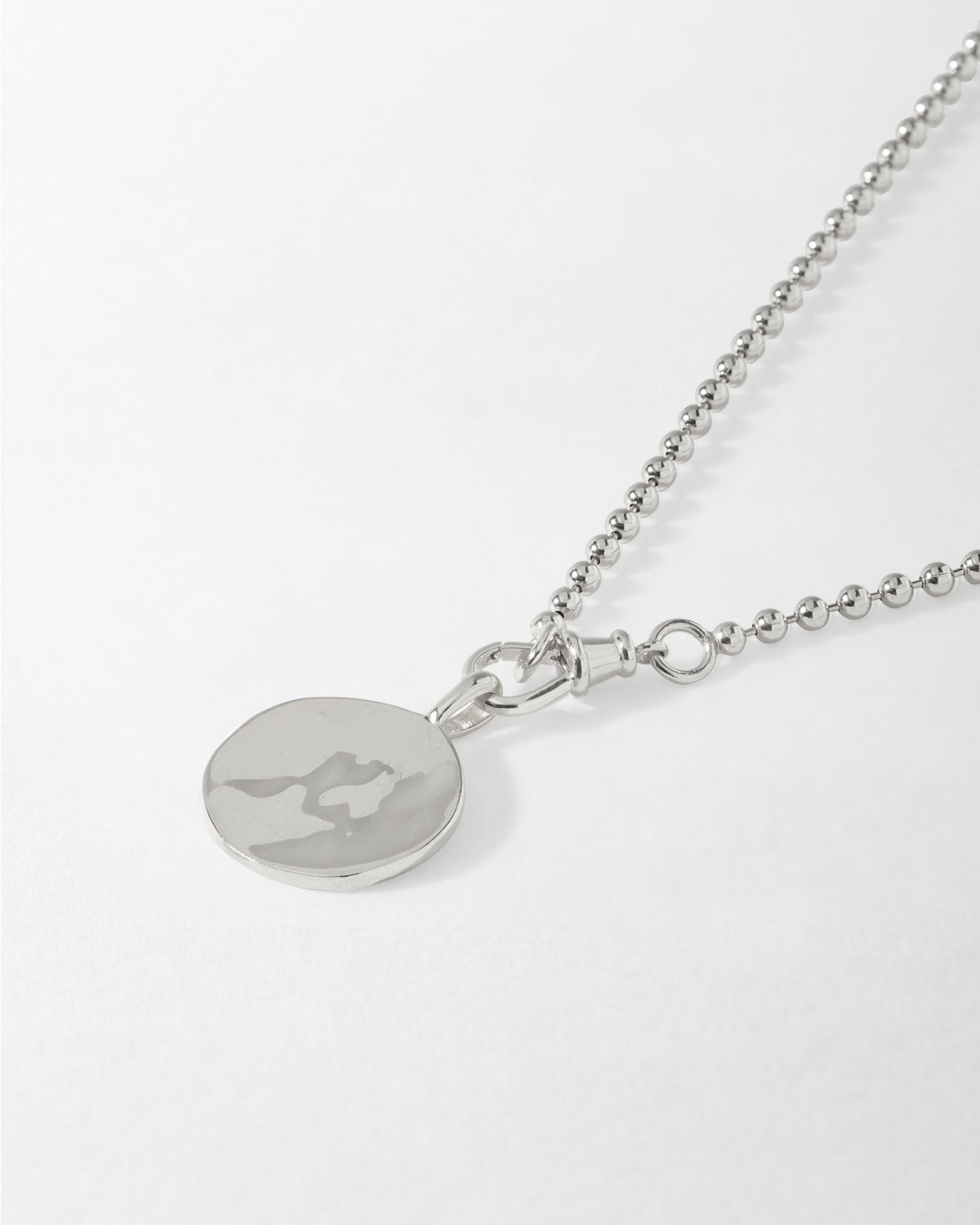 Coin Globe Necklace - Silver featuring a sterling silver pendant and chain, crafted from recycled metals with ethical sourcing for fine jewellery that lasts.