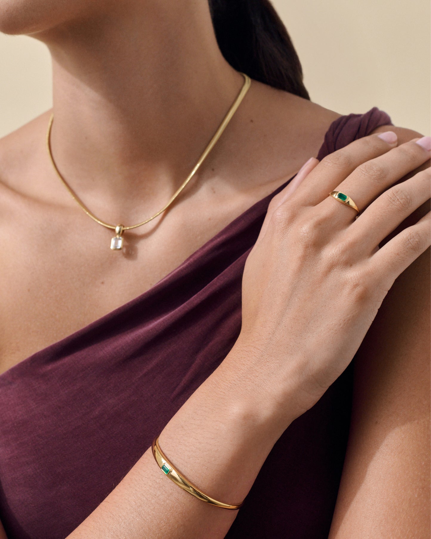 Close-up of a woman wearing the Pebble Green Onyx Cuff in gold-plated sterling silver paired with a gold necklace, showcasing sustainable, ethically sourced fine jewellery designed for everyday luxury.