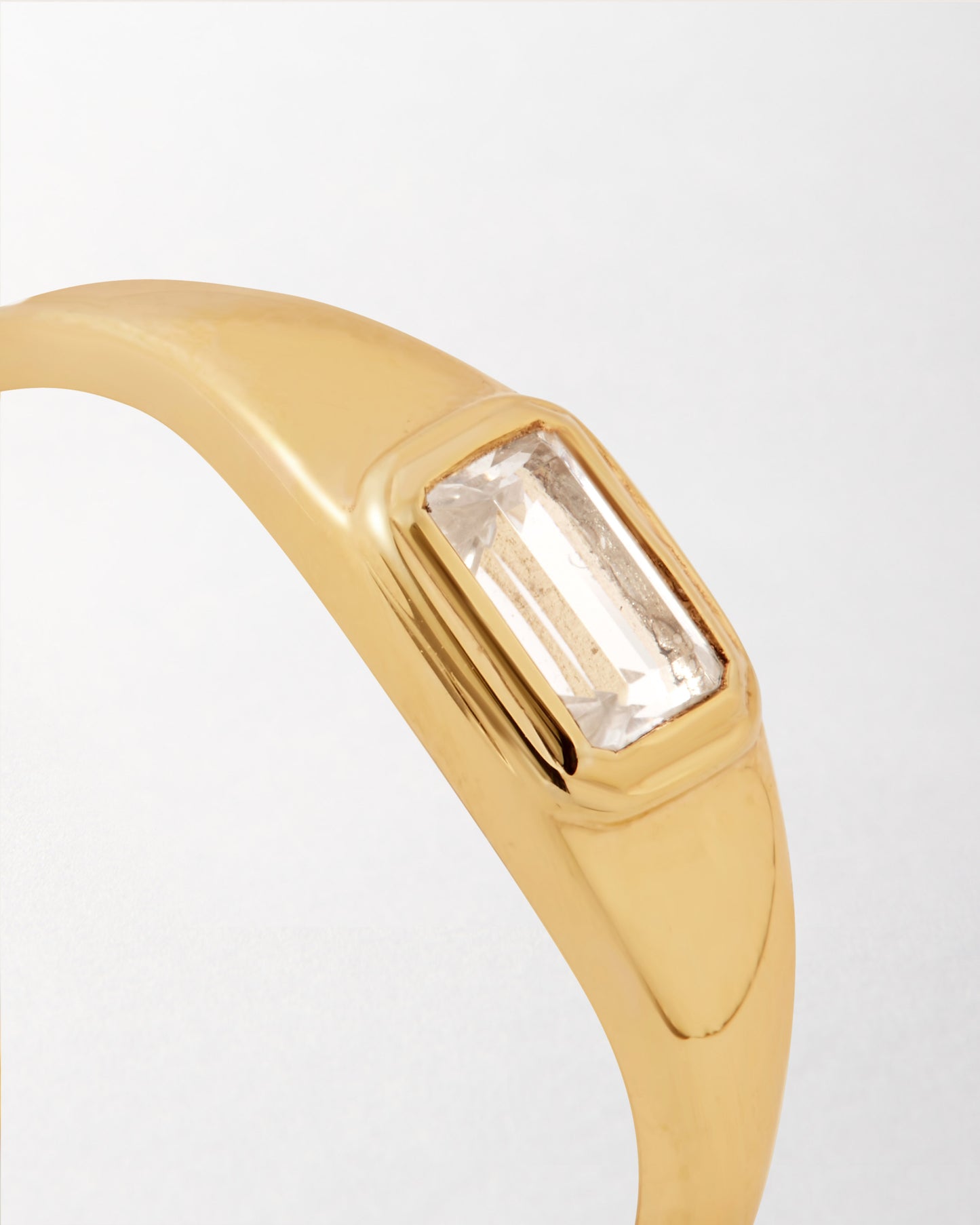 Pebble White Topaz Ring featuring a rectangular white topaz set in a sleek gold-plated band, crafted with recycled metals for considered, fine jewellery made to last.