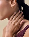 Close-up of a person wearing the Pebble White Topaz Ring in gold-plated sterling silver, showcasing fine sustainable craftsmanship with elegant, ethical style.