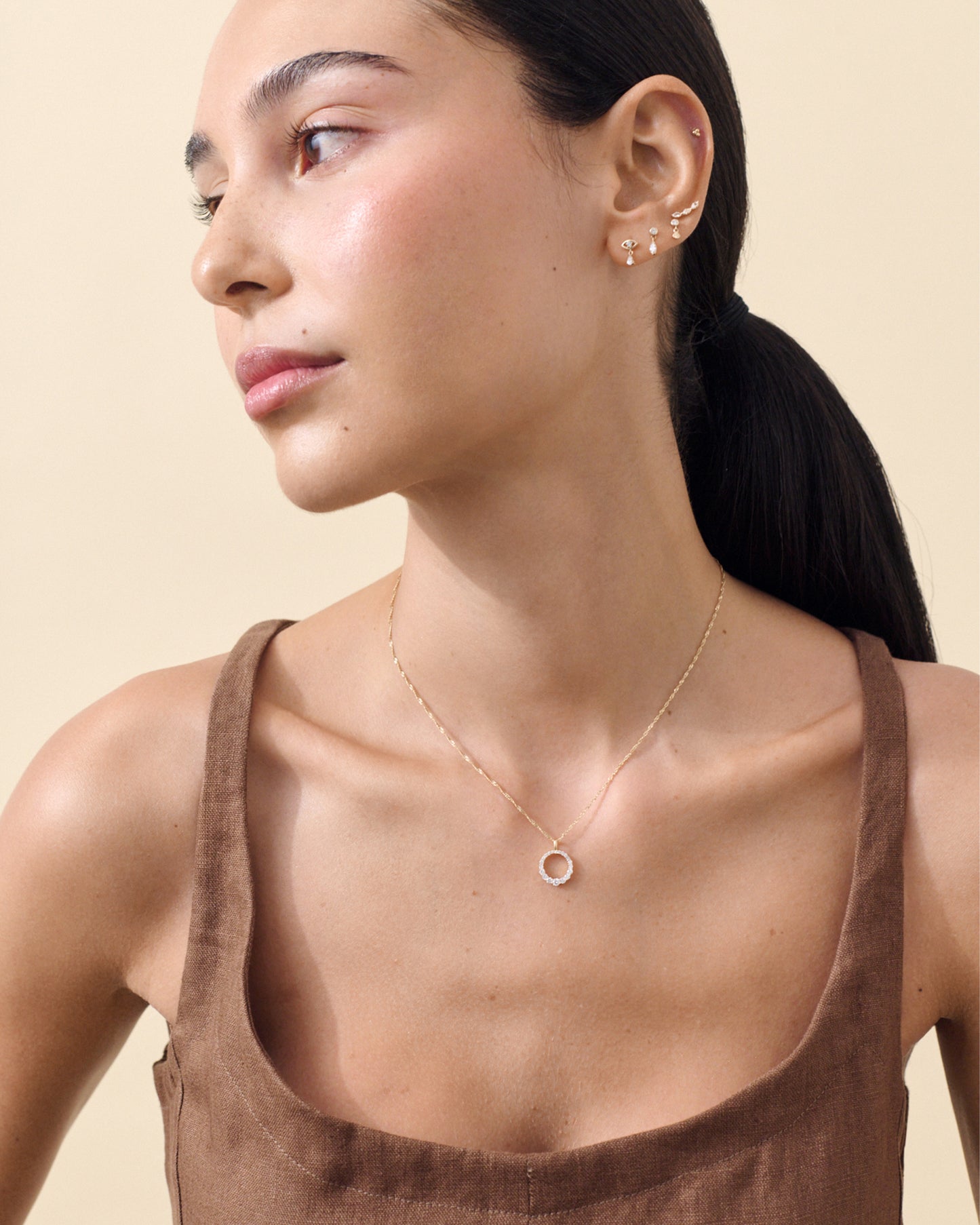 Woman wearing a Diamond Halo Necklace made of solid gold with a delicate pendant and chain, showcasing ethical, recycled metals and lab-grown diamonds for fine everyday jewellery.