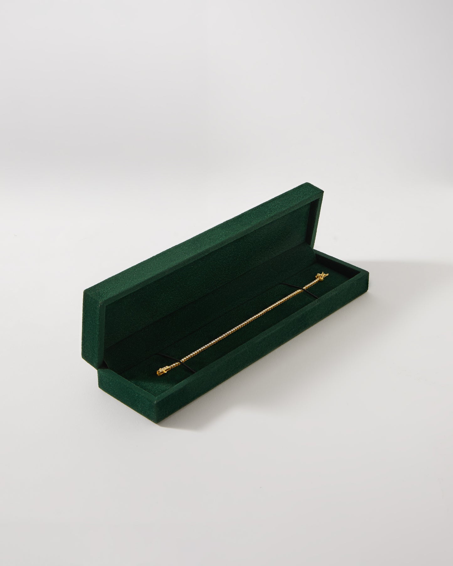 Solid Gold Lab-Grown Diamond Tennis Bracelet displayed in an elegant green velvet box, crafted from recycled metals with lab-grown diamonds for considered everyday fine jewellery.