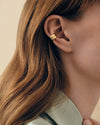 Close-up of a woman's ear wearing the Charlotte Collins Dome Pavé Double Ear-cuff crafted in gold-plated sterling silver, showcasing sustainable fine jewellery made from recycled metals with lab-grown diamonds.