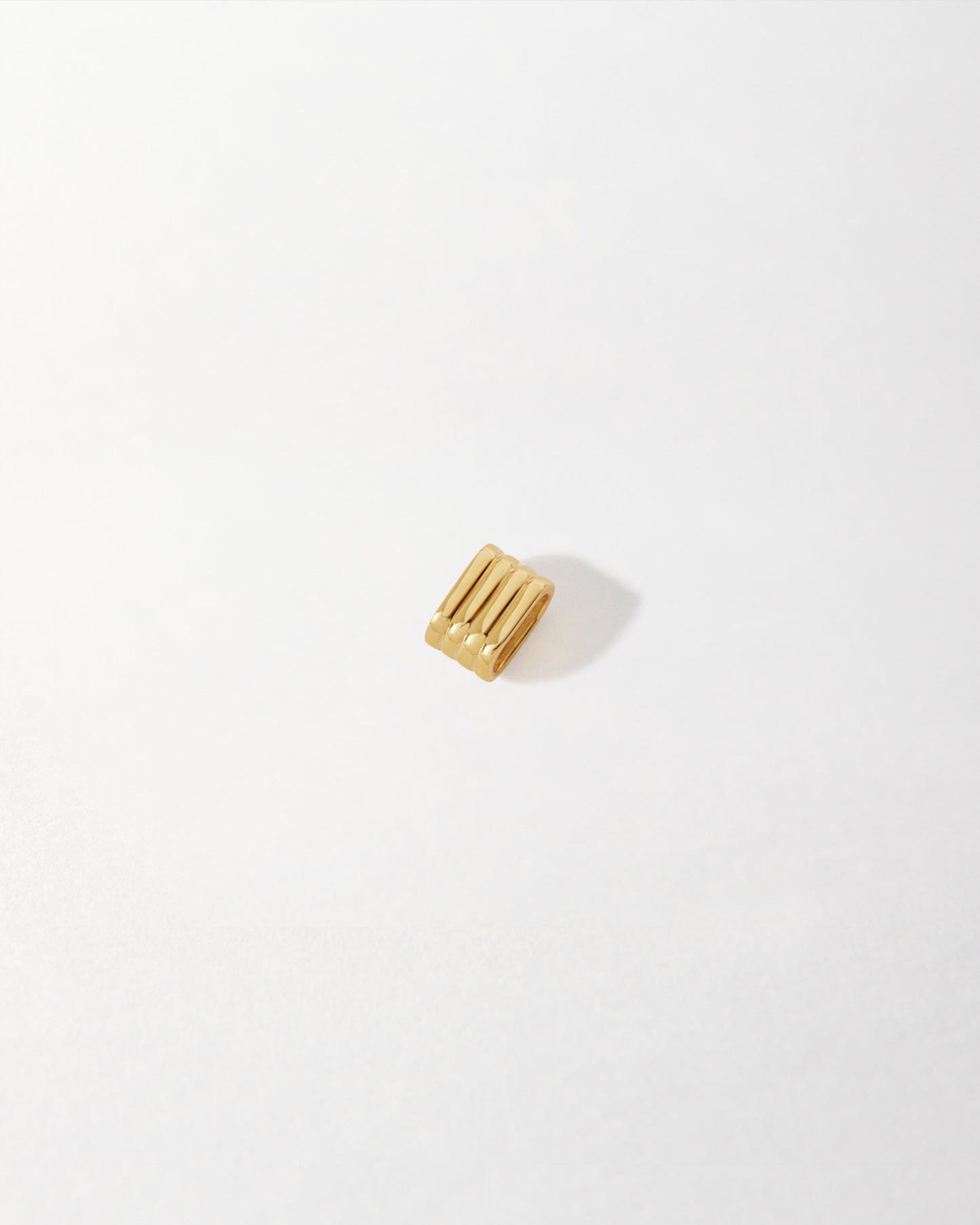 Mini 18ct Gold Necklace Spacer crafted from sustainable recycled metals, designed for fine jewellery layering with an elegant gold-plated finish. Considered jewellery. Solid gold. Fine jewellery for the everyday. Made in recycled metals. Built to last.