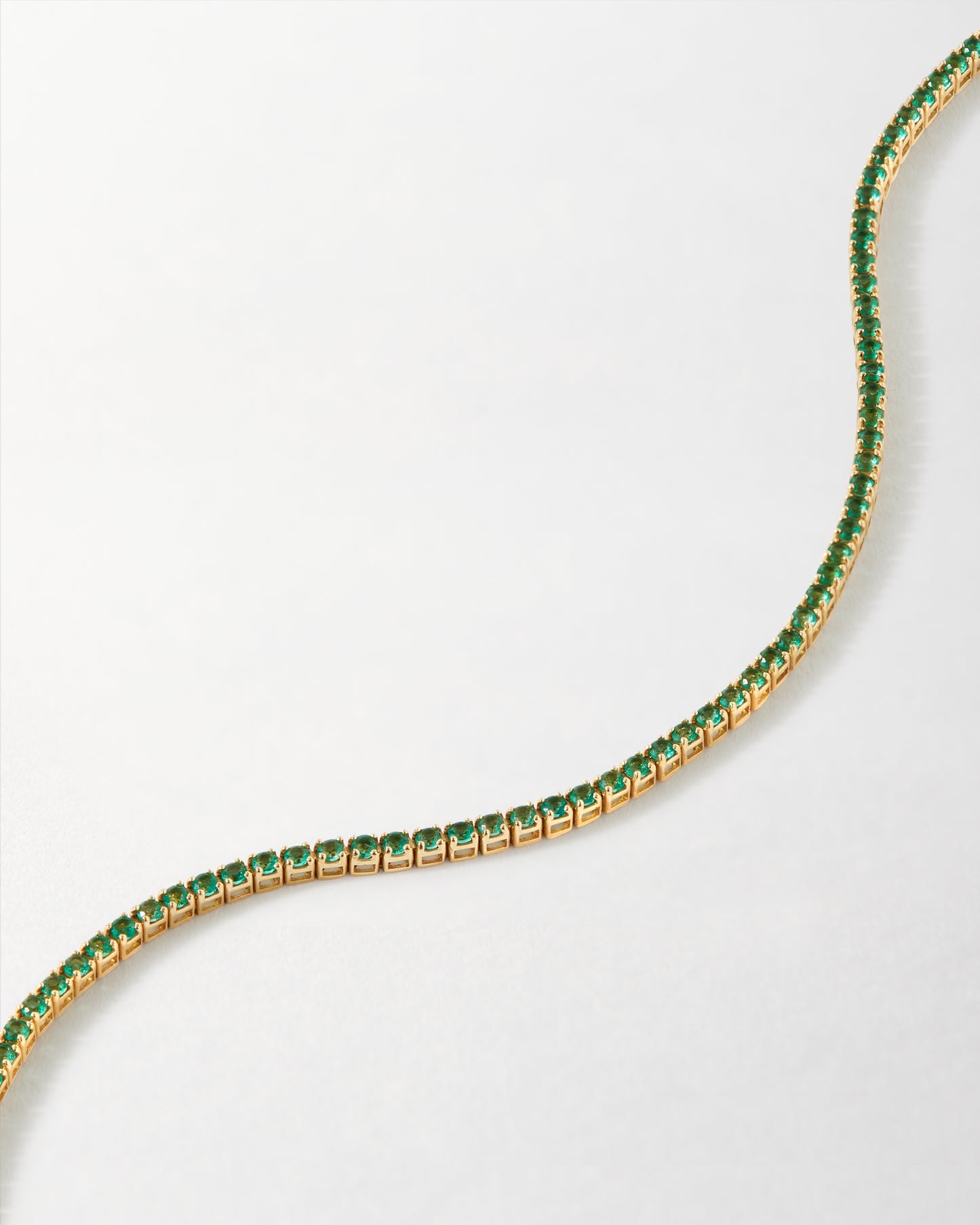 Solid Gold Lab-Grown Emerald Tennis Bracelet featuring bright green lab-grown emeralds set in recycled solid 14ct gold, combining ethical sourcing with everyday fine jewellery.