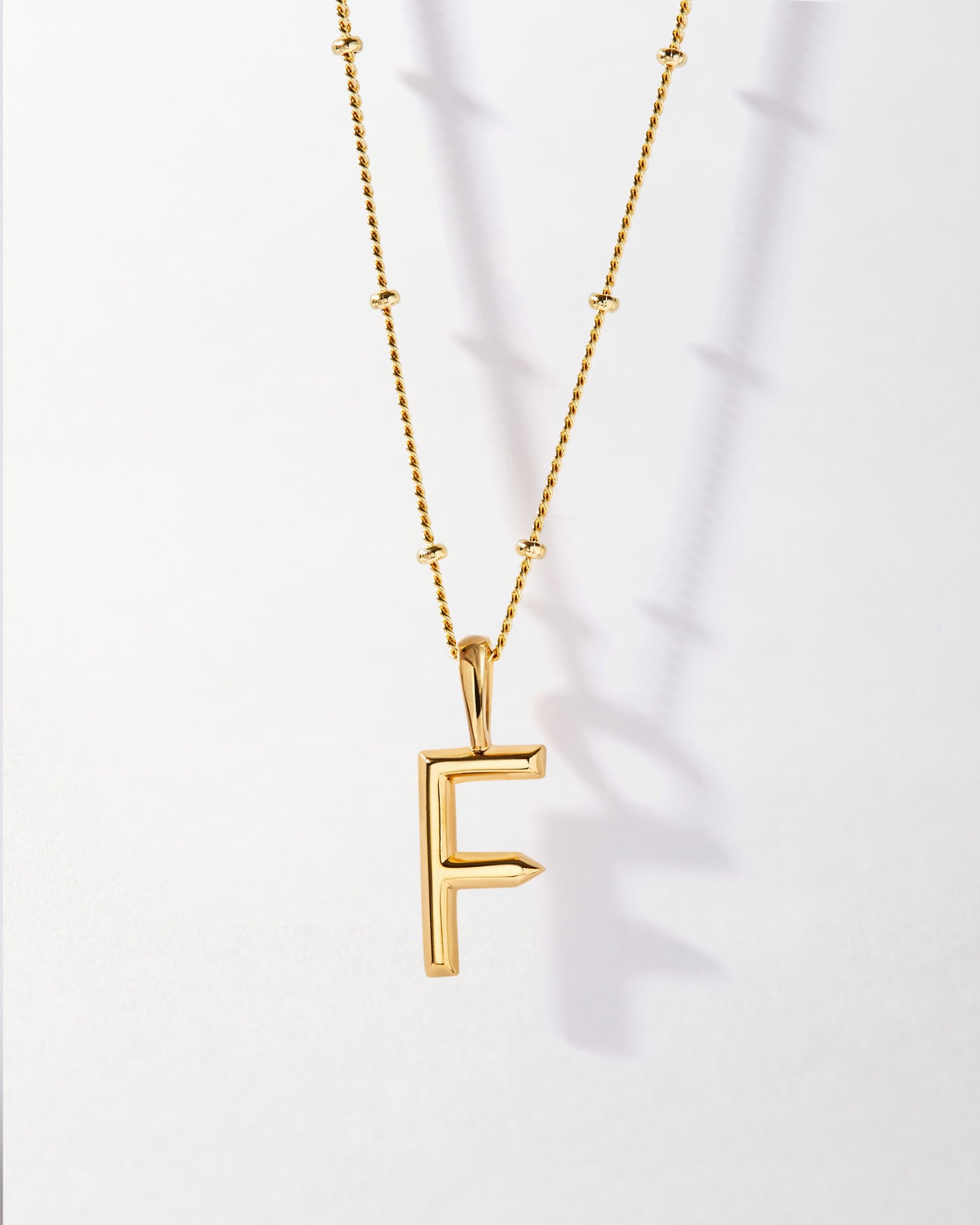 F' Initial Necklace - Gold featuring a delicate gold-plated pendant on a fine chain, crafted from recycled metals for everyday fine jewellery with ethical sourcing.