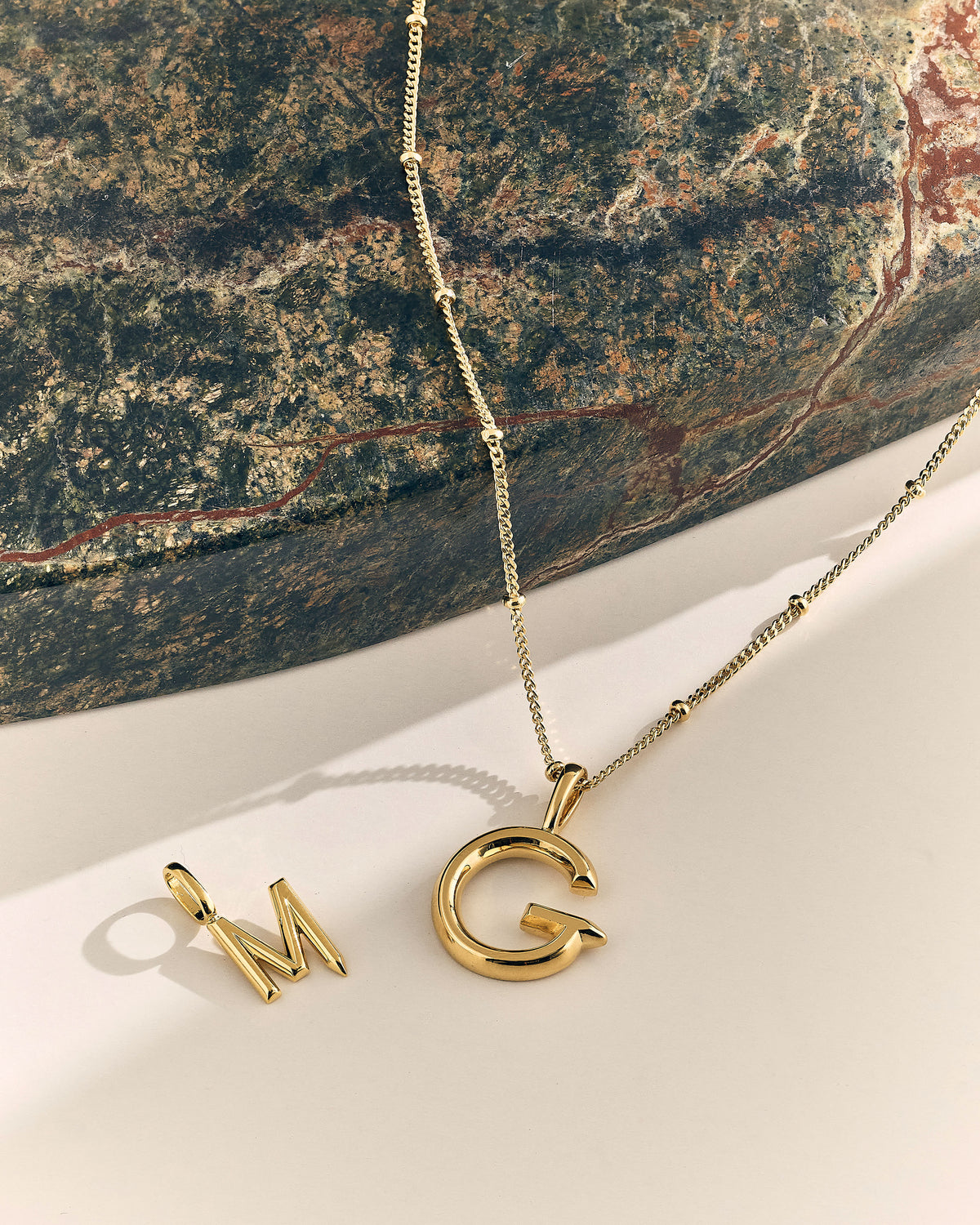 Family Initial Necklace with gold plated M and C pendant initials on a delicate chain for a personalised jewellery gift for mum