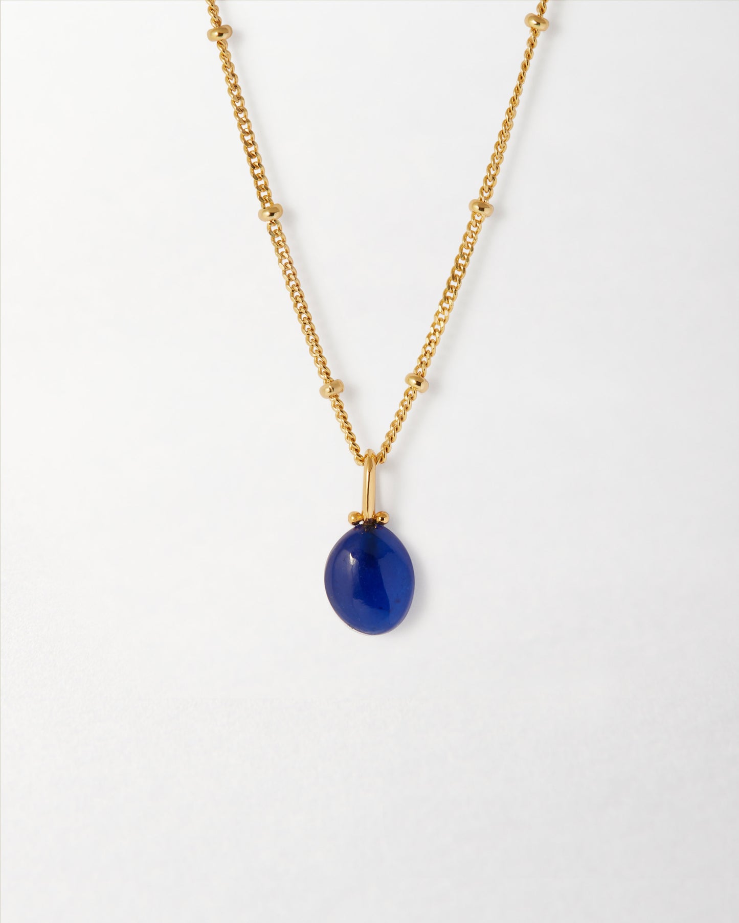 Coastal Blue Quartz Necklace featuring a deep blue quartz pendant on a gold-plated chain, crafted from recycled metals with ethical sourcing and built to last.