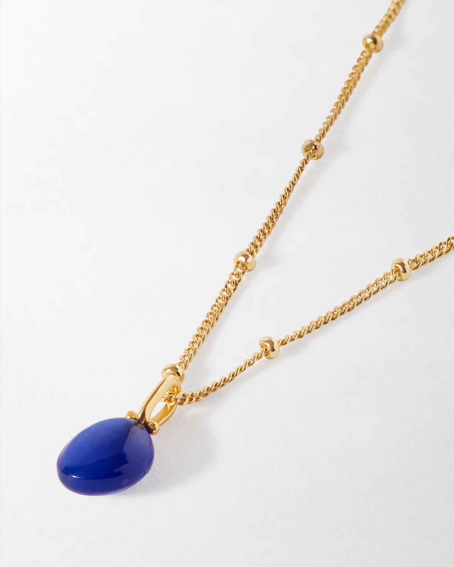 Coastal Blue Quartz Necklace featuring a gold-plated chain with delicate bead accents and a polished blue quartz pendant, crafted in recycled metals for fine, ethical jewellery.