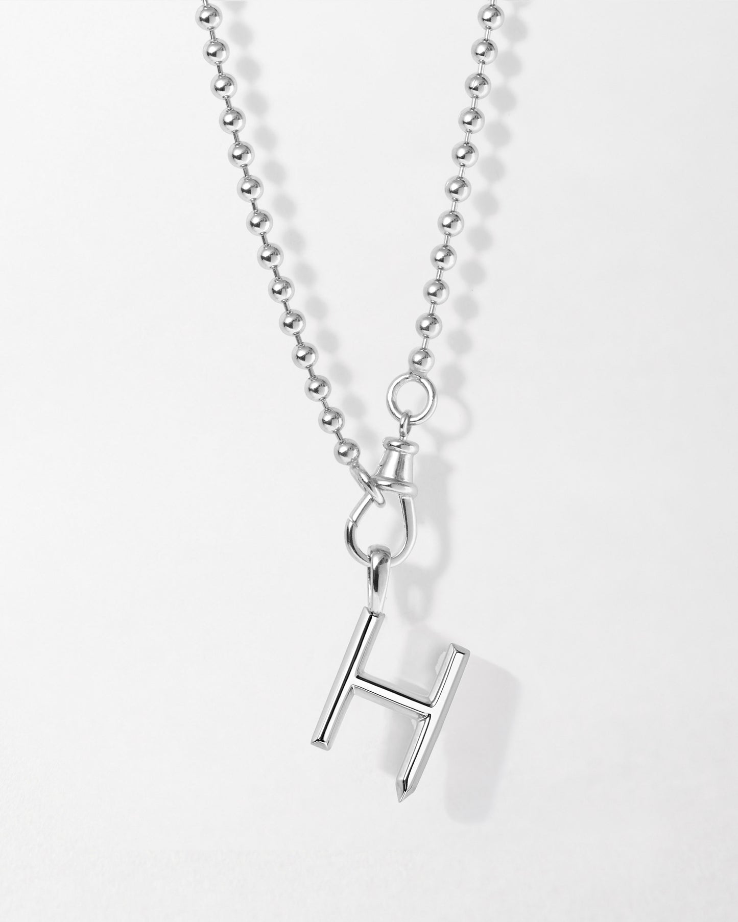 Initial Globe Necklace - Silver featuring a sterling silver pendant in the shape of the letter H on a delicate ball chain, crafted with recycled metals for timeless, ethical fine jewellery.
