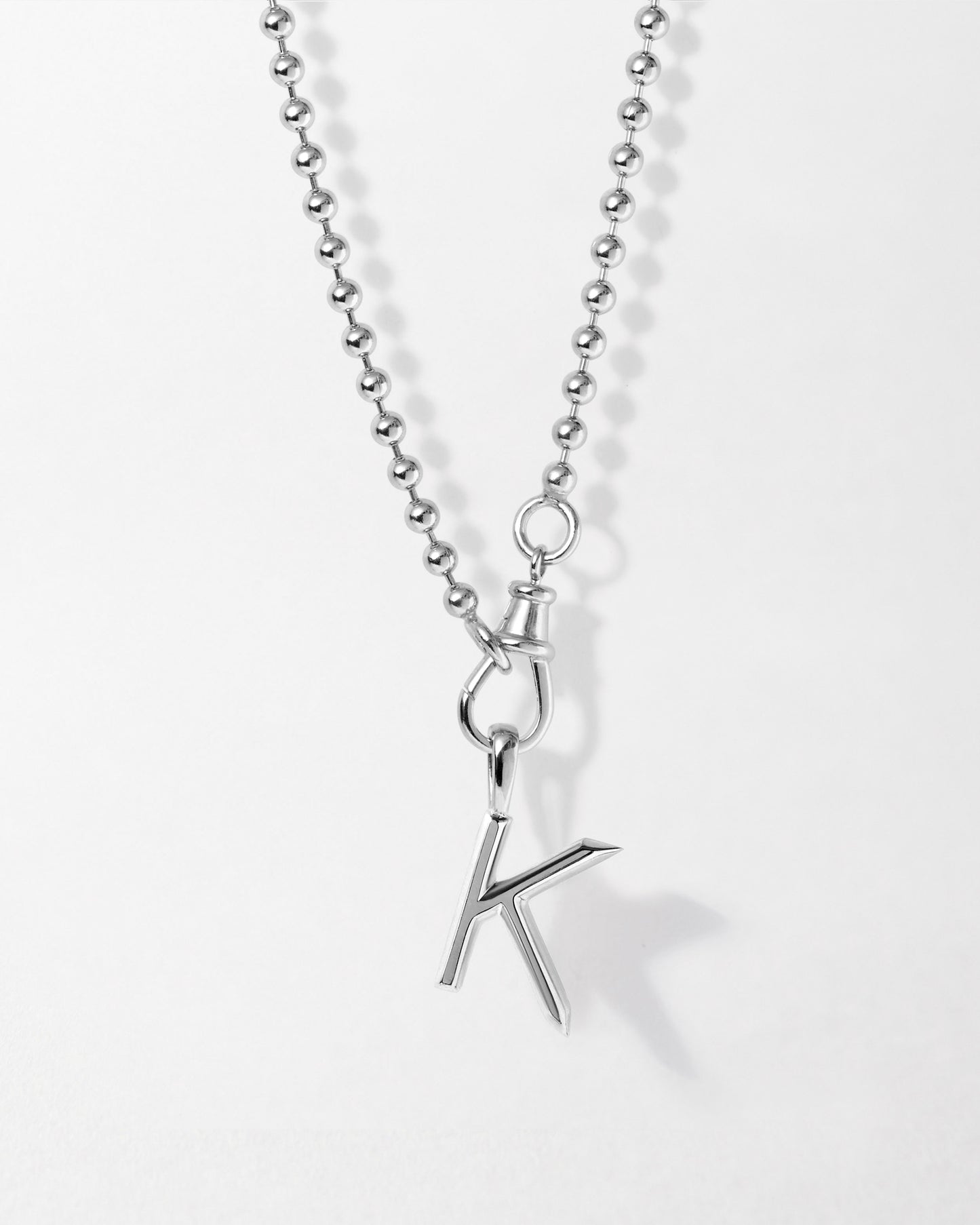 Initial Globe Necklace - Silver featuring a sterling silver pendant with a polished letter K hanging from a delicate ball chain, crafted in recycled metals for ethical, fine jewellery made to last.