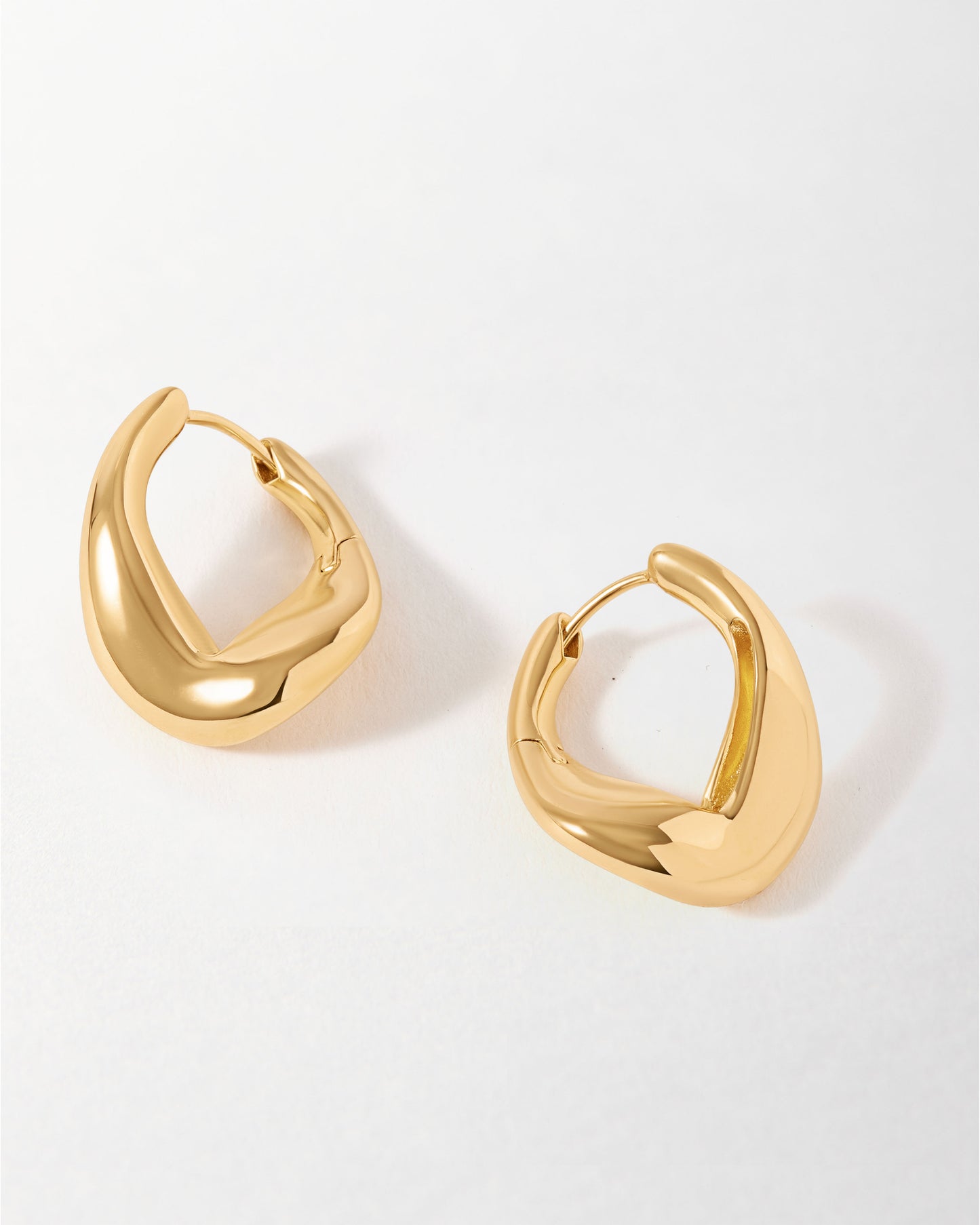 Charlotte Collins Large Twist Hoop Earrings in polished gold-plated sterling silver, showcasing a modern, sustainable twist design made from recycled metals, perfect for everyday fine jewellery.