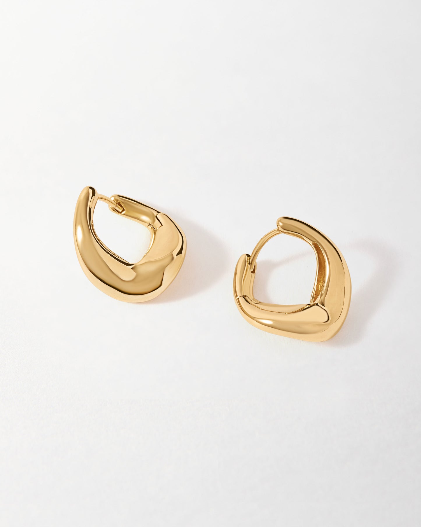 Charlotte Collins Medium Twist Hoop Earrings in polished gold-plated sterling silver, designed with a modern twisted shape for stylish, sustainable fine jewellery made to last.