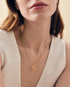 Close-up of a woman wearing a Mini Spinner Pendant necklace made from gold-plated and sterling silver, showcasing considered jewellery crafted from recycled metals with ethical sourcing.