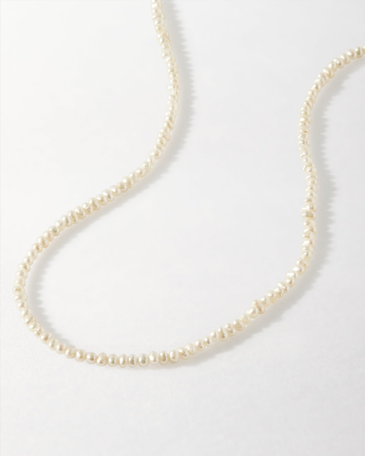 Mini Pearl Strand featuring delicate beaded pearls on gold-plated and sterling silver chain, combining considered jewellery with sustainable, ethical sourcing and timeless style.