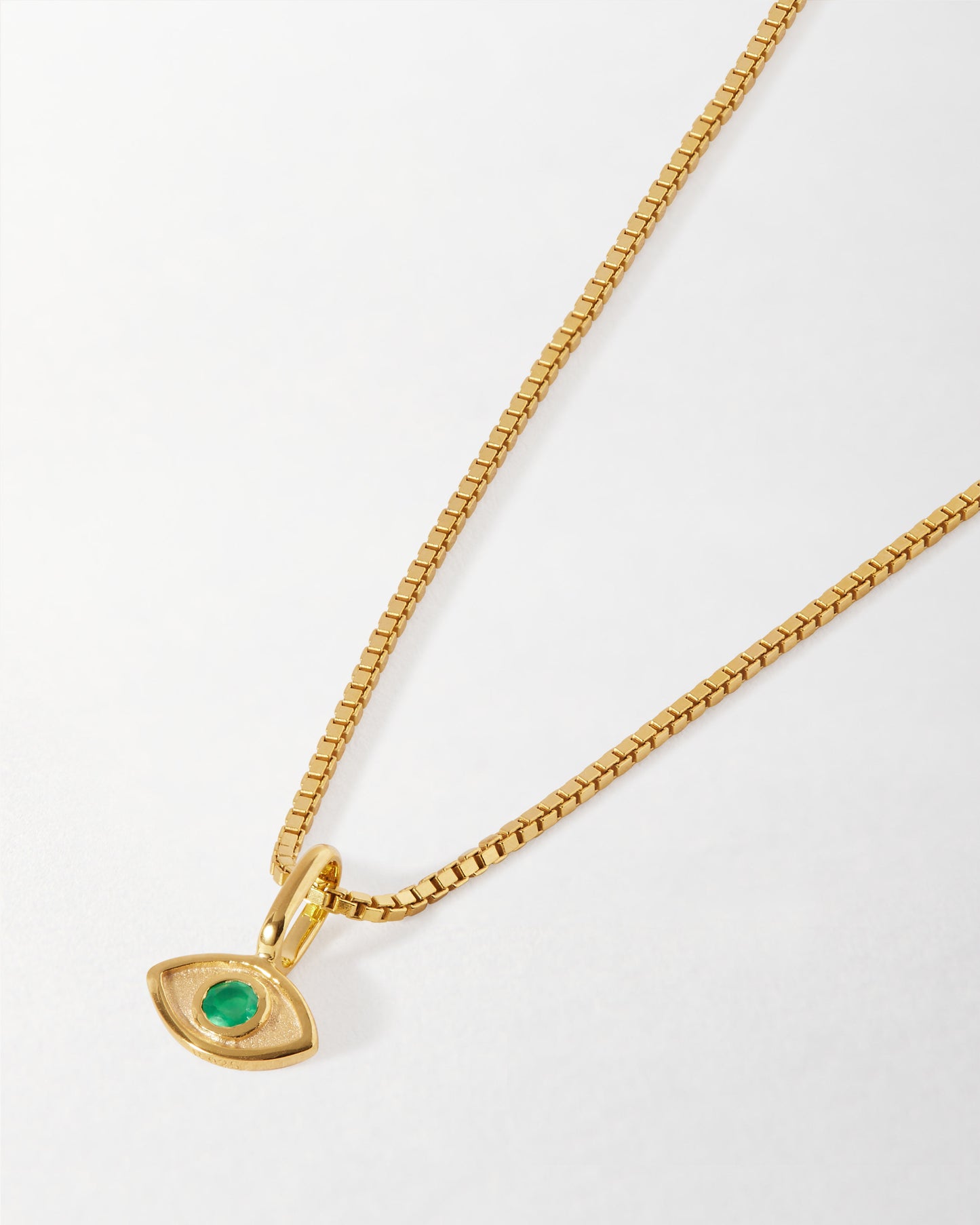 Mini Evil Eye Necklace in gold-plated sterling silver featuring a green stone pendant on a delicate chain, crafted with recycled metals and ethical sourcing.