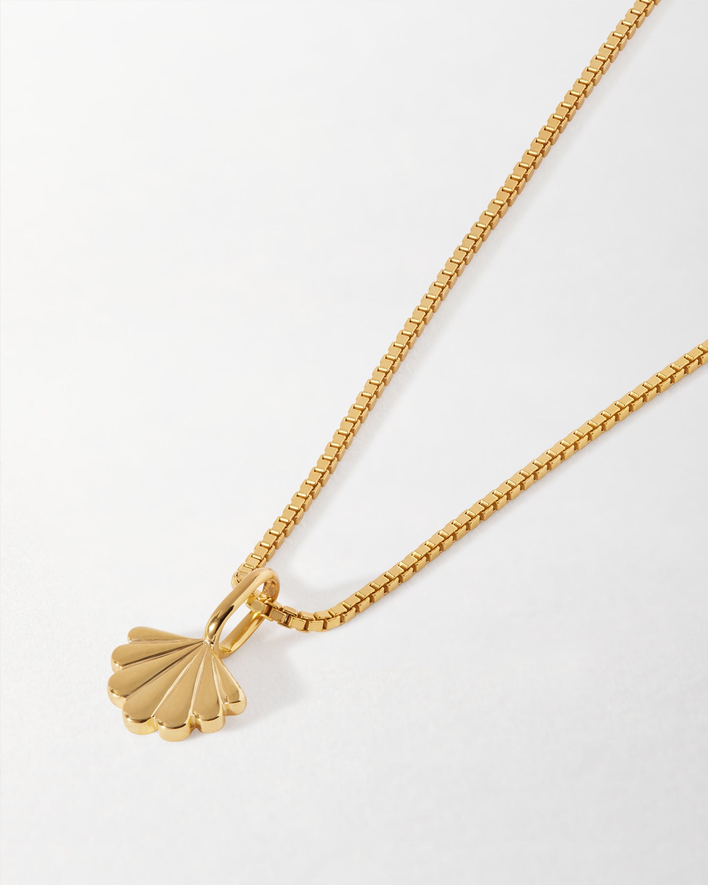 Mini Shell Necklace in gold-plated sterling silver featuring a delicate shell pendant on a fine chain, crafted with ethical, recycled metals and designed for everyday luxury.