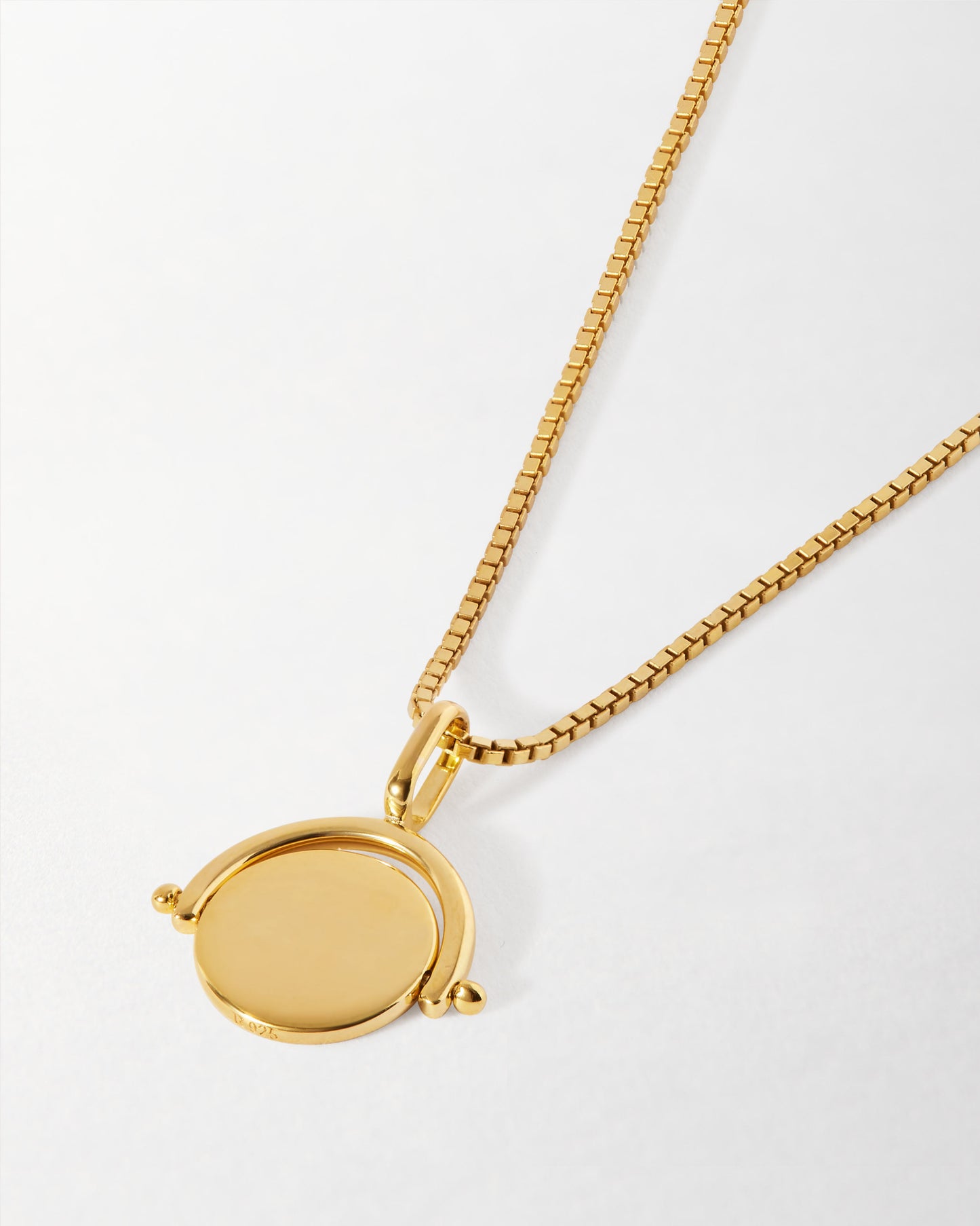 Mini Spinner Necklace featuring a gold-plated pendant on a delicate chain, crafted from recycled metals with ethical sourcing, embodying considered jewellery made to last.