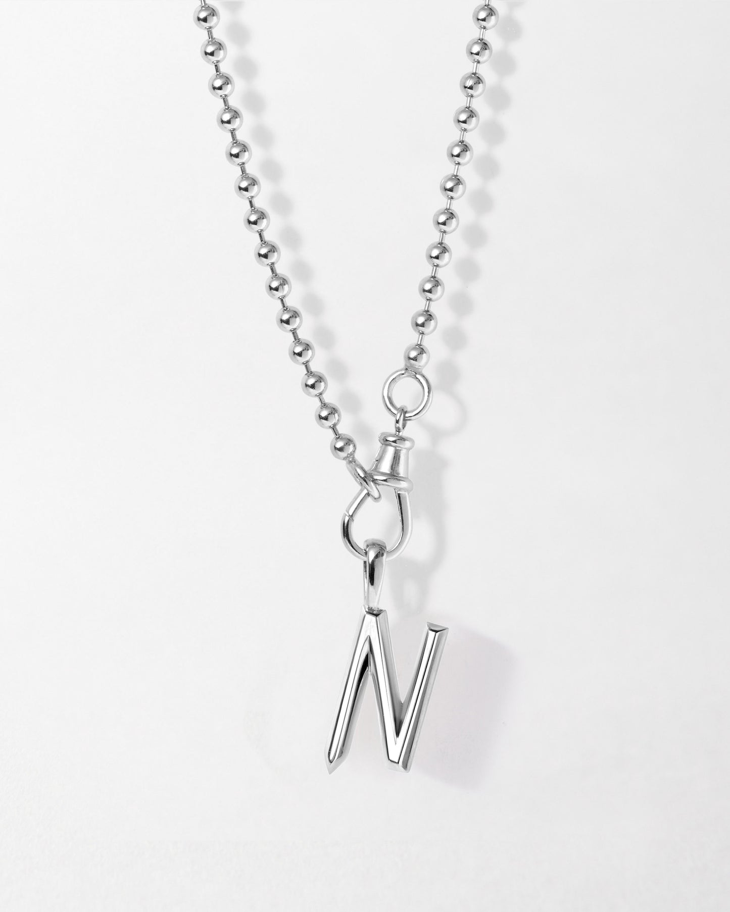 Initial Globe Necklace - Silver featuring a sleek sterling silver pendant with the letter N on a delicate chain, crafted in recycled metals with ethical sourcing.