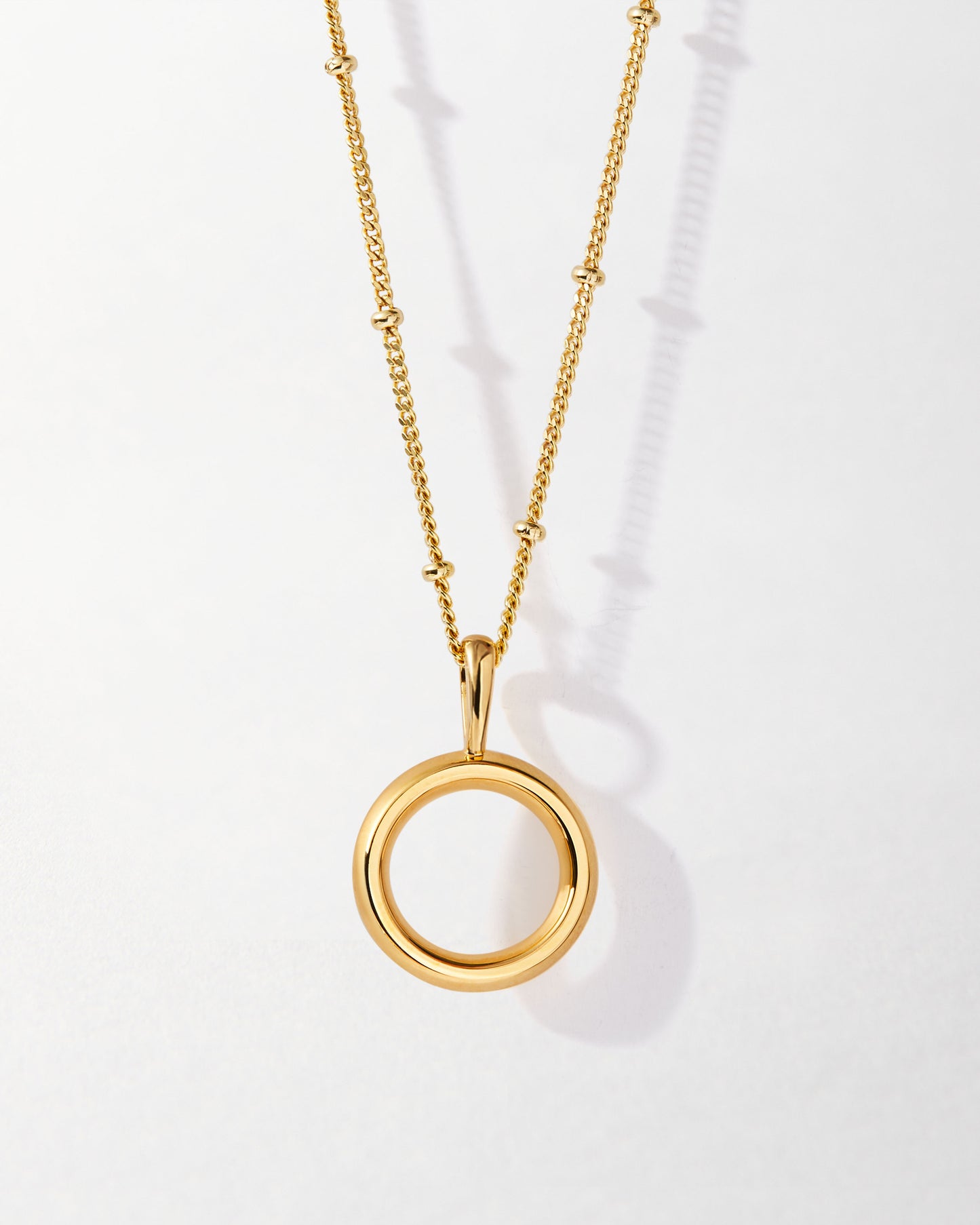 O' Initial Necklace - Gold featuring a polished gold-plated pendant on a delicate chain, crafted from recycled metals to offer sustainable fine jewellery built to last.