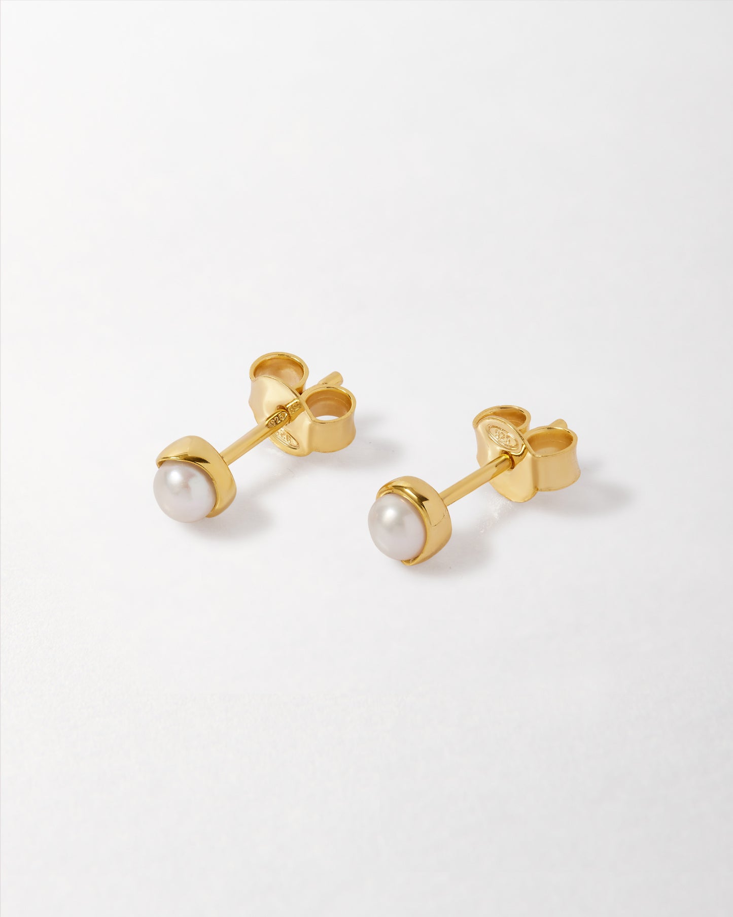 Pearl Stud Earring featuring gold-plated settings with sterling silver posts, combining ethical sourcing and recycled metals for fine jewellery made to last.