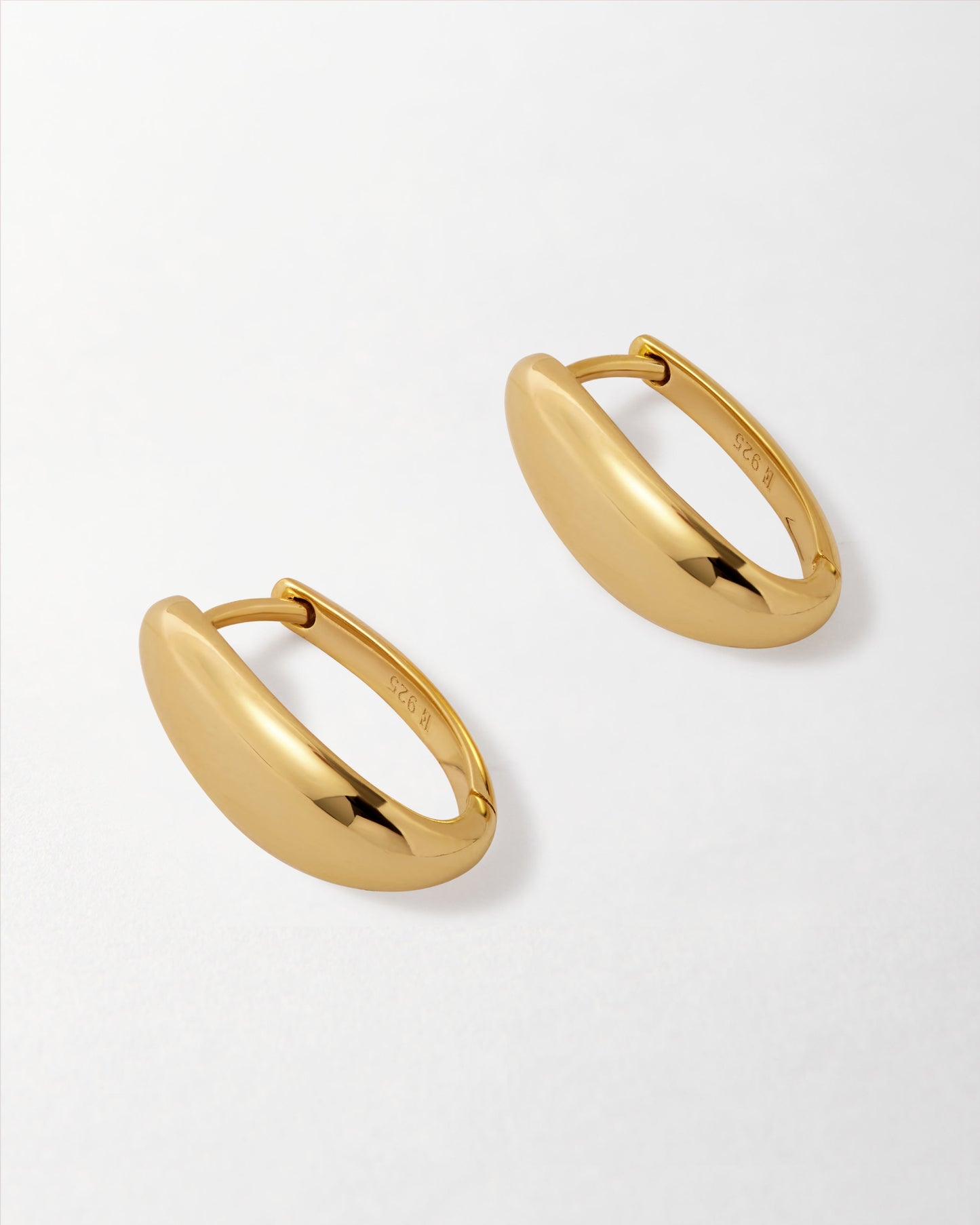 Pair of Medium Pebble Hoop Earrings - Gold in polished gold-plated sterling silver, showcasing a sleek dangle design crafted with recycled metals for everyday fine jewellery built to last.