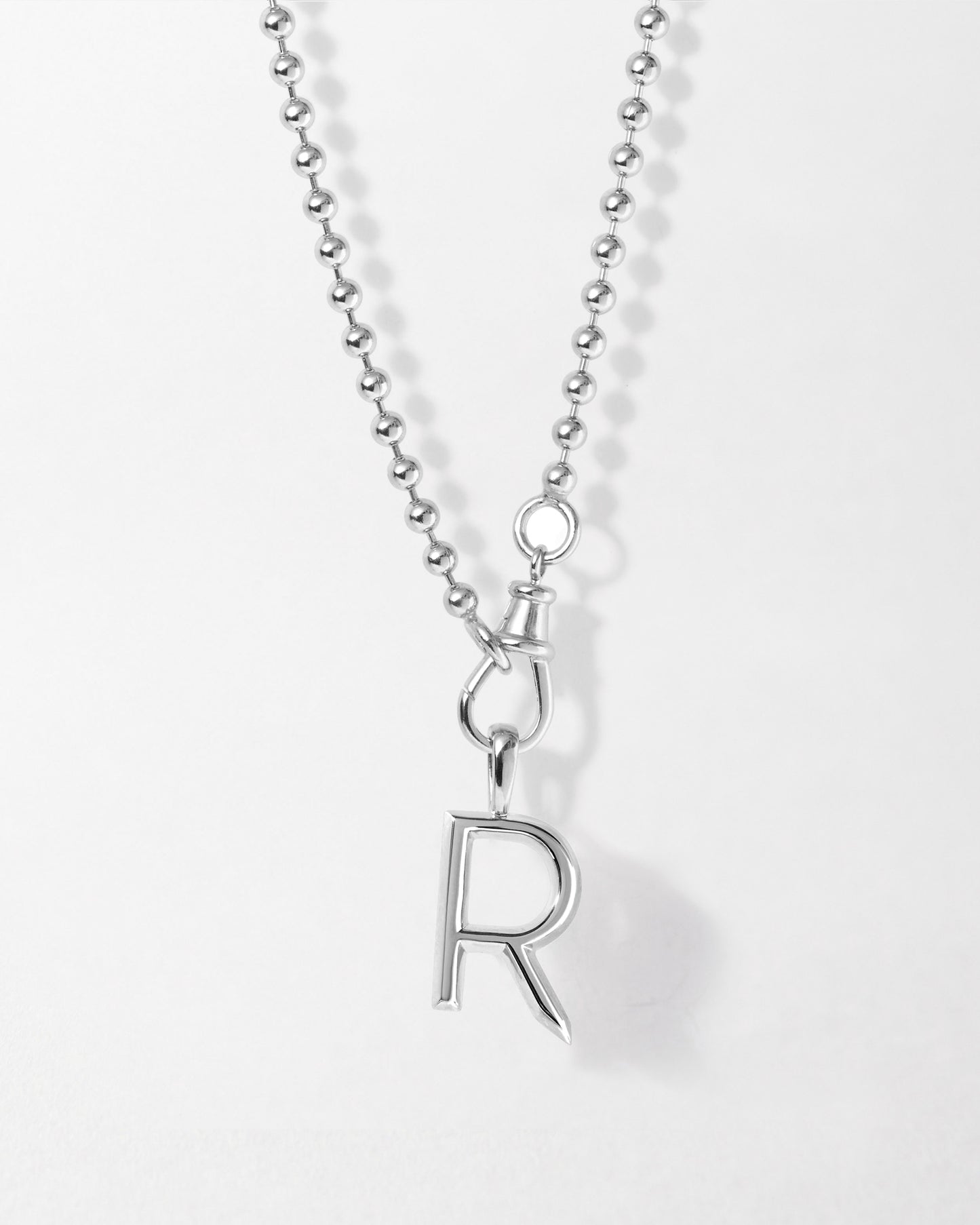 Initial Globe Necklace - Silver featuring a sterling silver ball chain and a pendant charm shaped like the letter R, crafted in recycled metals with ethical sourcing.
