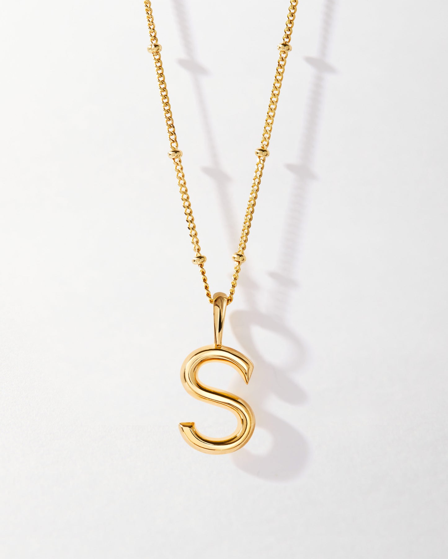 S' Initial Necklace - Gold featuring a polished gold-plated pendant in the shape of the letter S on a delicate chain, crafted with recycled metals and built to last.
