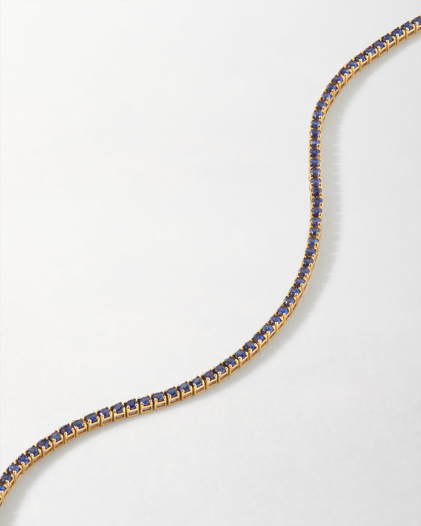 Solid Gold Lab-Grown Sapphire Tennis Bracelet featuring deep blue lab-grown sapphires set in solid 14ct gold, crafted using recycled metals with ethical sourcing for everyday fine jewellery.