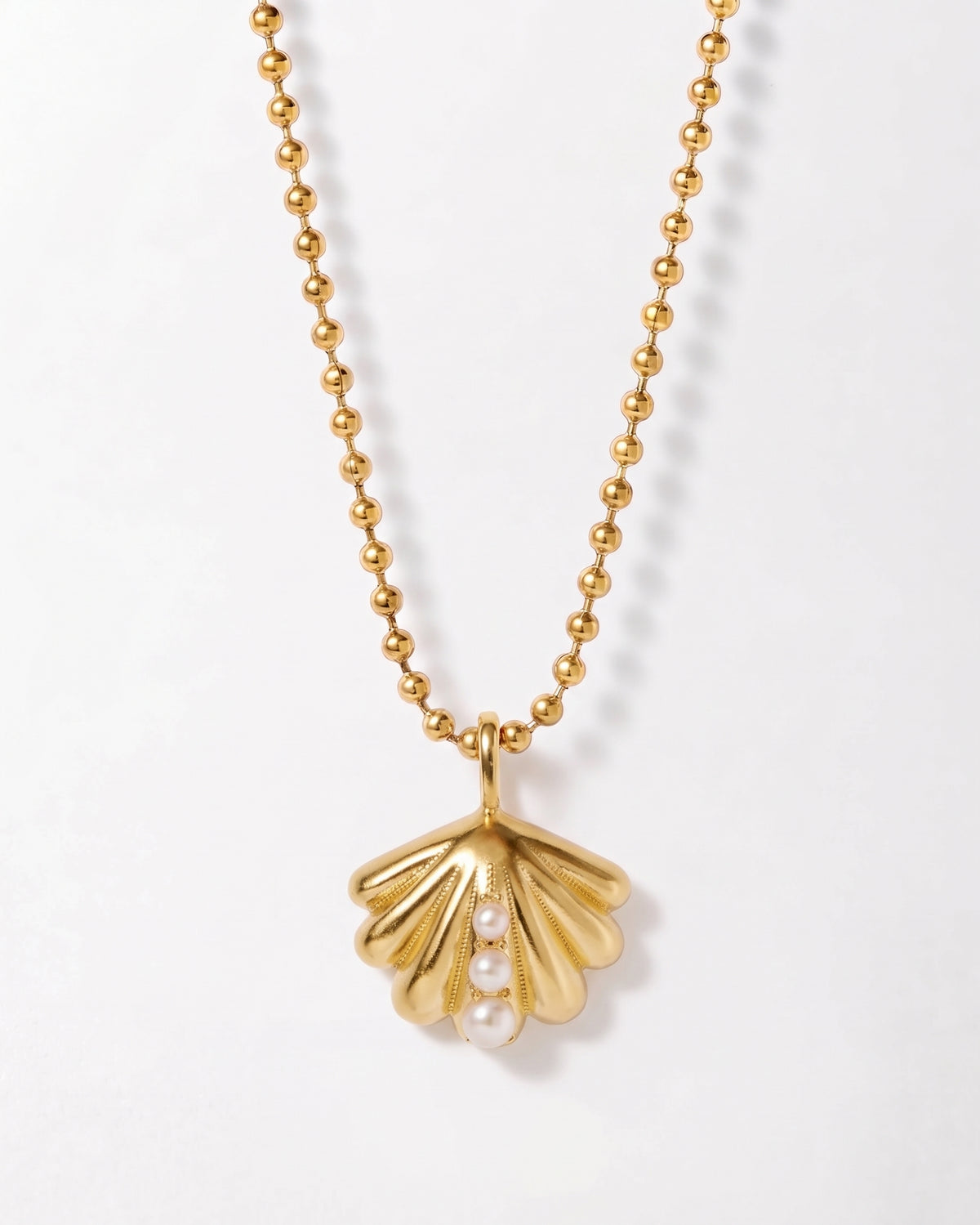 Ocean Shell Globe Necklace with a gold-plated shell pendant and beaded chain, crafted with sterling silver for a coastal inspired jewellery look