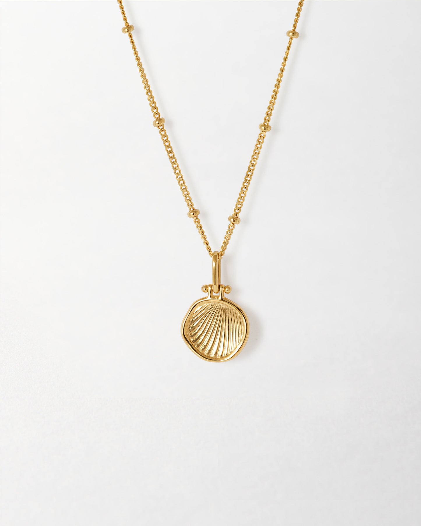 Delicate Coastal Shell Necklace crafted in gold-plated sterling silver, featuring a finely detailed shell pendant on a beaded chain, embodying considered jewellery made to last.