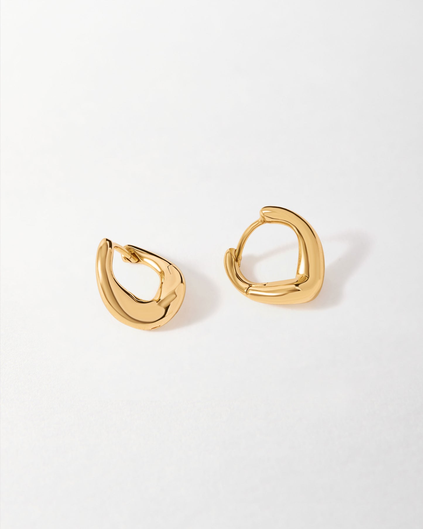 Charlotte Collins Small Twist Hoop Earrings in gold-plated sterling silver with a unique twisted hoop design, crafted as considered jewellery made in recycled metals.