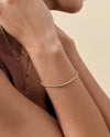 A delicate Solid Gold Lab-Grown Diamond Tennis Bracelet worn on a wrist, showcasing elegant craftsmanship in recycled metals designed for everyday fine jewellery.