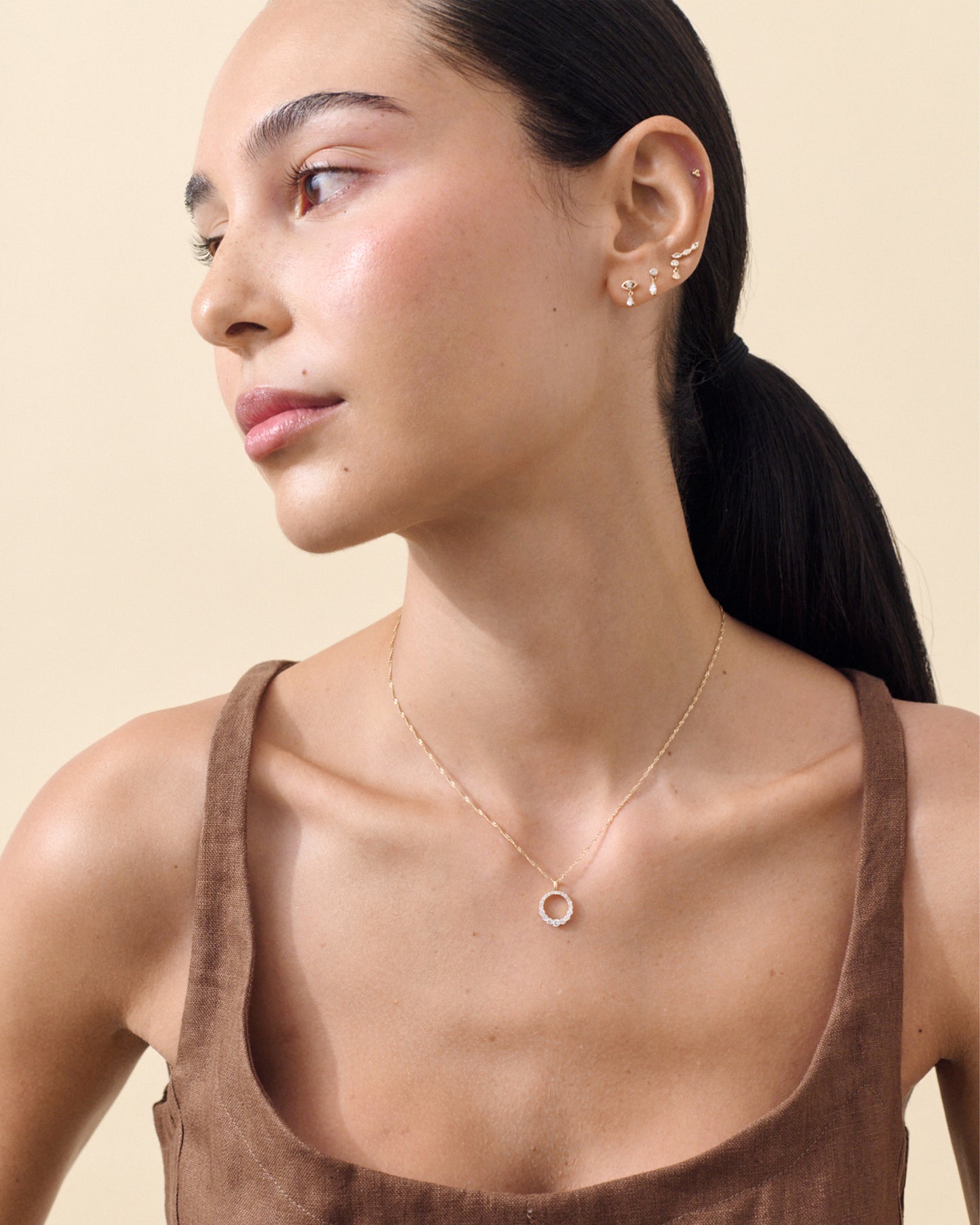 Close-up of a woman wearing a Solid Gold Lab-Grown Marquise Diamond Piercing Earring on her ear, showcasing fine jewellery crafted from recycled metals and lab-grown diamonds.