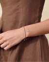 Close-up of a person wearing the Solid Gold Lab-Grown Sapphire Tennis Bracelet in 14ct recycled metals, showcasing fine craftsmanship and ethical sourcing for everyday luxury.