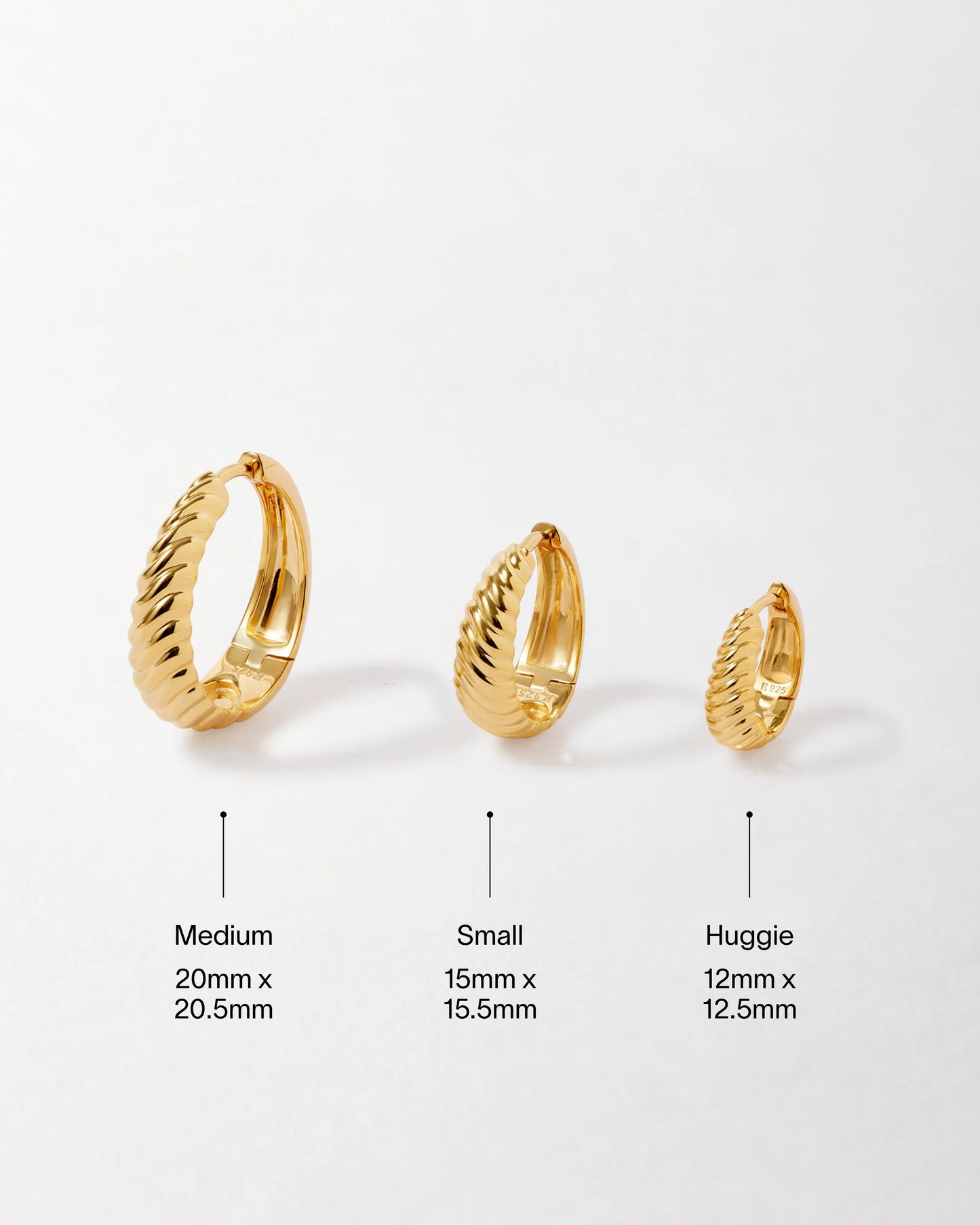 Three sizes of Spiral Medium Hoop Earrings - Gold displayed side by side, crafted from gold-plated sterling silver with a twisted design, showcasing sustainable, solid gold jewellery made from recycled metals.