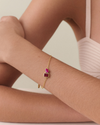 A delicate Toi Et Moi Courage Bracelet featuring two vibrant pink gemstones set in solid 14ct gold on a fine chain, crafted from recycled metals with ethical sourcing.