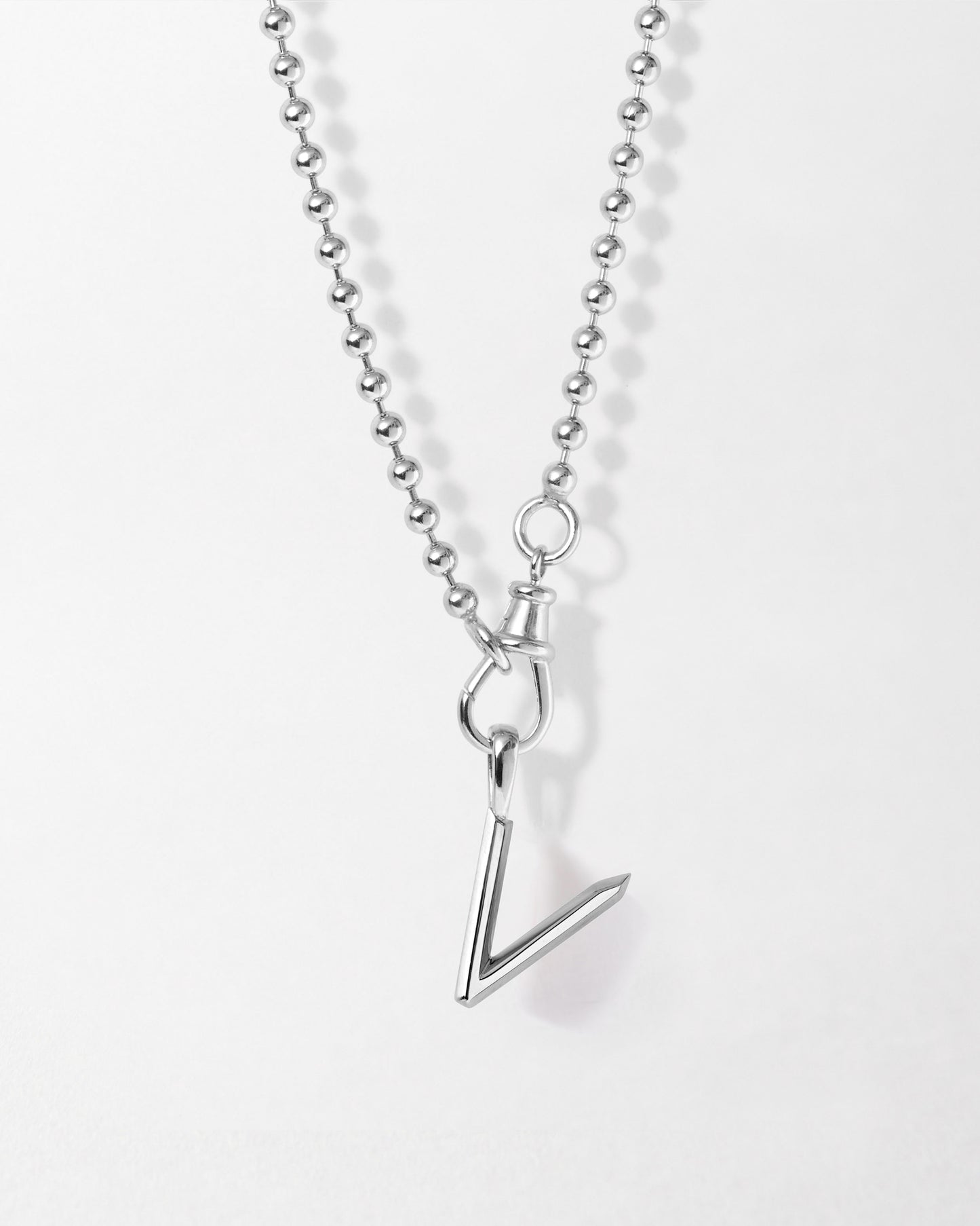 Initial Globe Necklace - Silver featuring a sterling silver pendant shaped like the letter V on a delicate silver ball chain, crafted with recycled metals for sustainable fine jewellery.