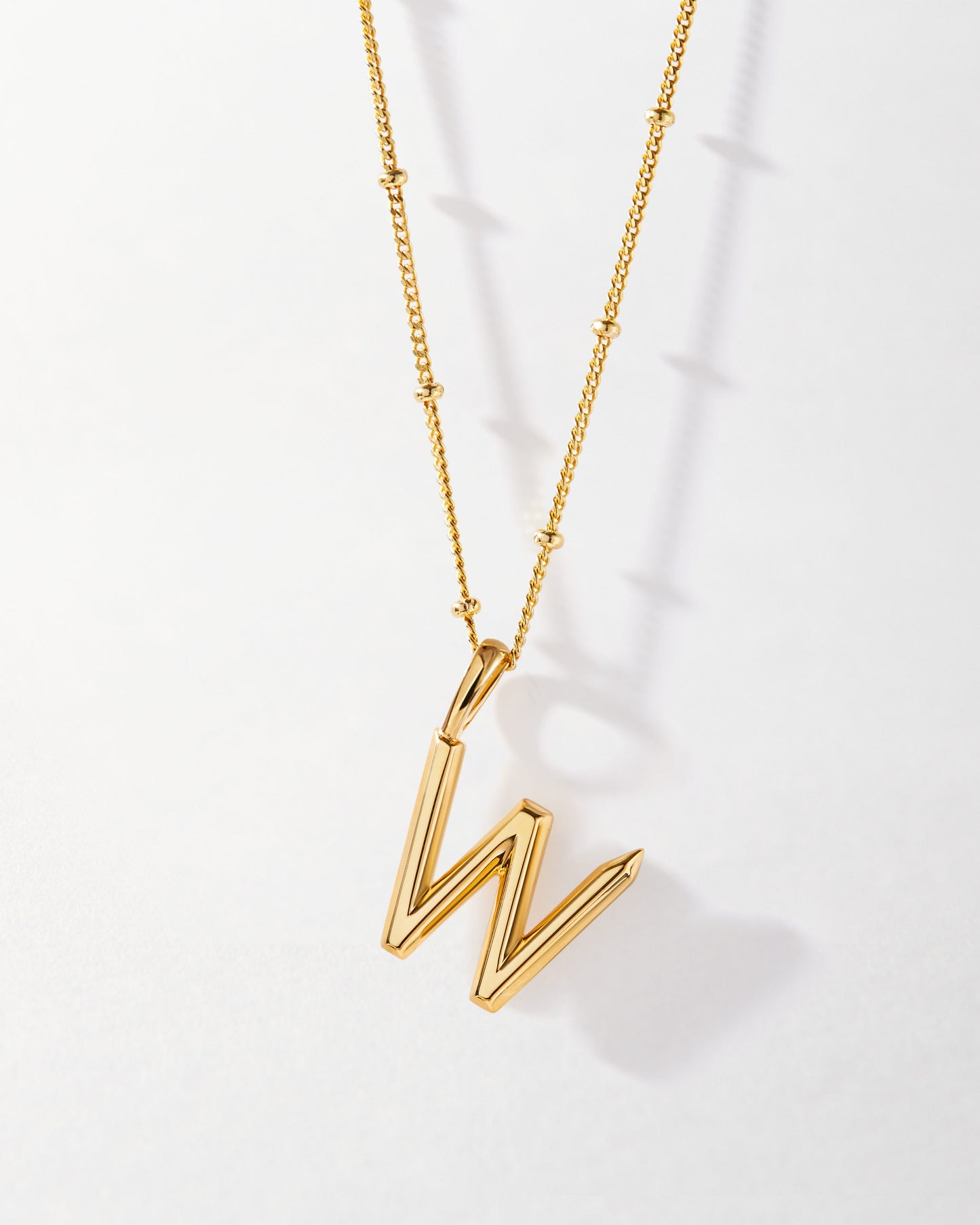 W' Initial Necklace - Gold pendant featuring a gold-plated chain with delicate bead details, crafted from recycled metals for considered, ethical fine jewellery made to last.