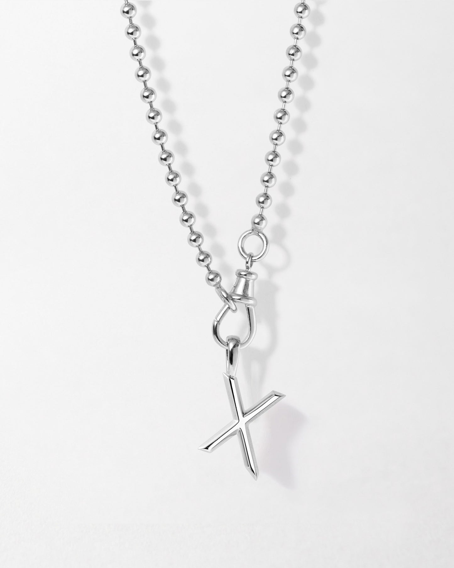 Initial Globe Necklace - Silver featuring a sterling silver pendant shaped like a stylized X on a delicate ball chain, crafted with recycled metals for considered everyday fine jewellery.