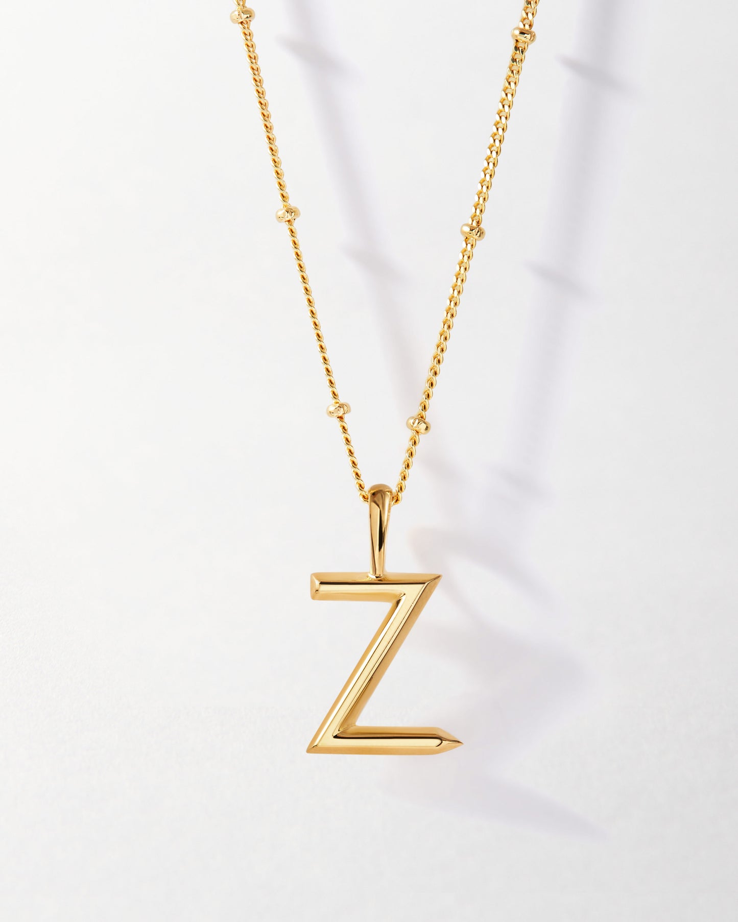 Z' Initial Necklace - Gold features a sleek gold-plated pendant in the shape of the letter Z on a delicate chain, made with recycled metals for everyday fine jewellery with ethical sourcing.