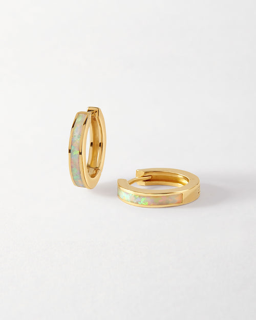 Opal Huggie Earrings crafted in solid gold with iridescent opal inlay, showcasing considered, sustainable fine jewellery made from recycled metals, built to last.
